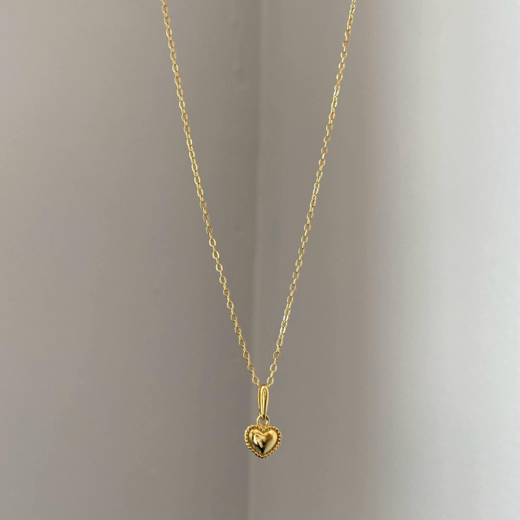 Front view of the KahiraN 14K gold-plated tiny heart pendant necklace by Kampy Designs, highlighting its minimalist and timeless heart charm.