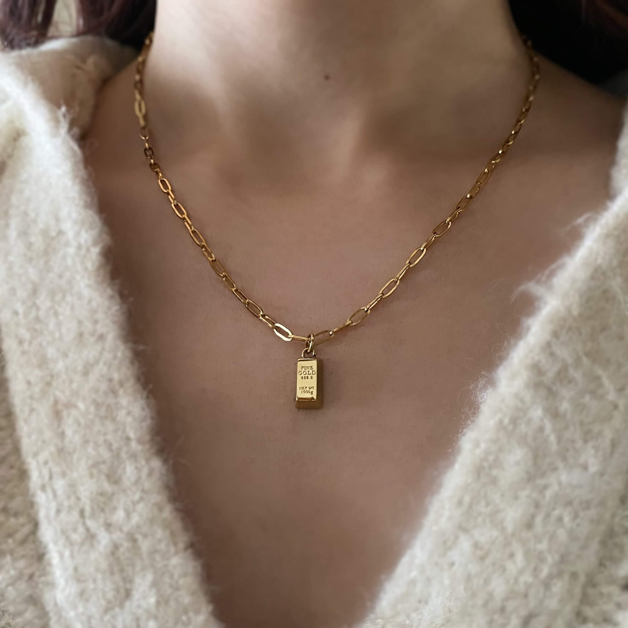 The KoldyN 18K gold bar pendant necklace by Kampy Designs, stylishly worn to highlight its elegant pendant and sleek gold-plated finish.
