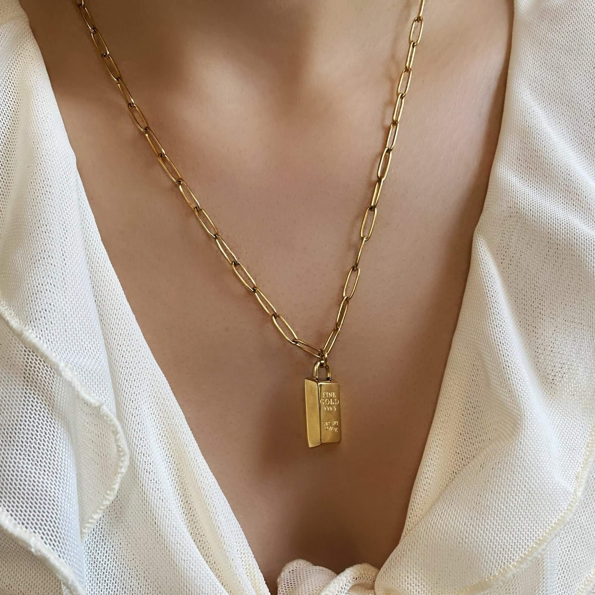 The KoldyN 18K gold bar pendant necklace by Kampy Designs, worn as a statement piece for a sophisticated and modern touch.