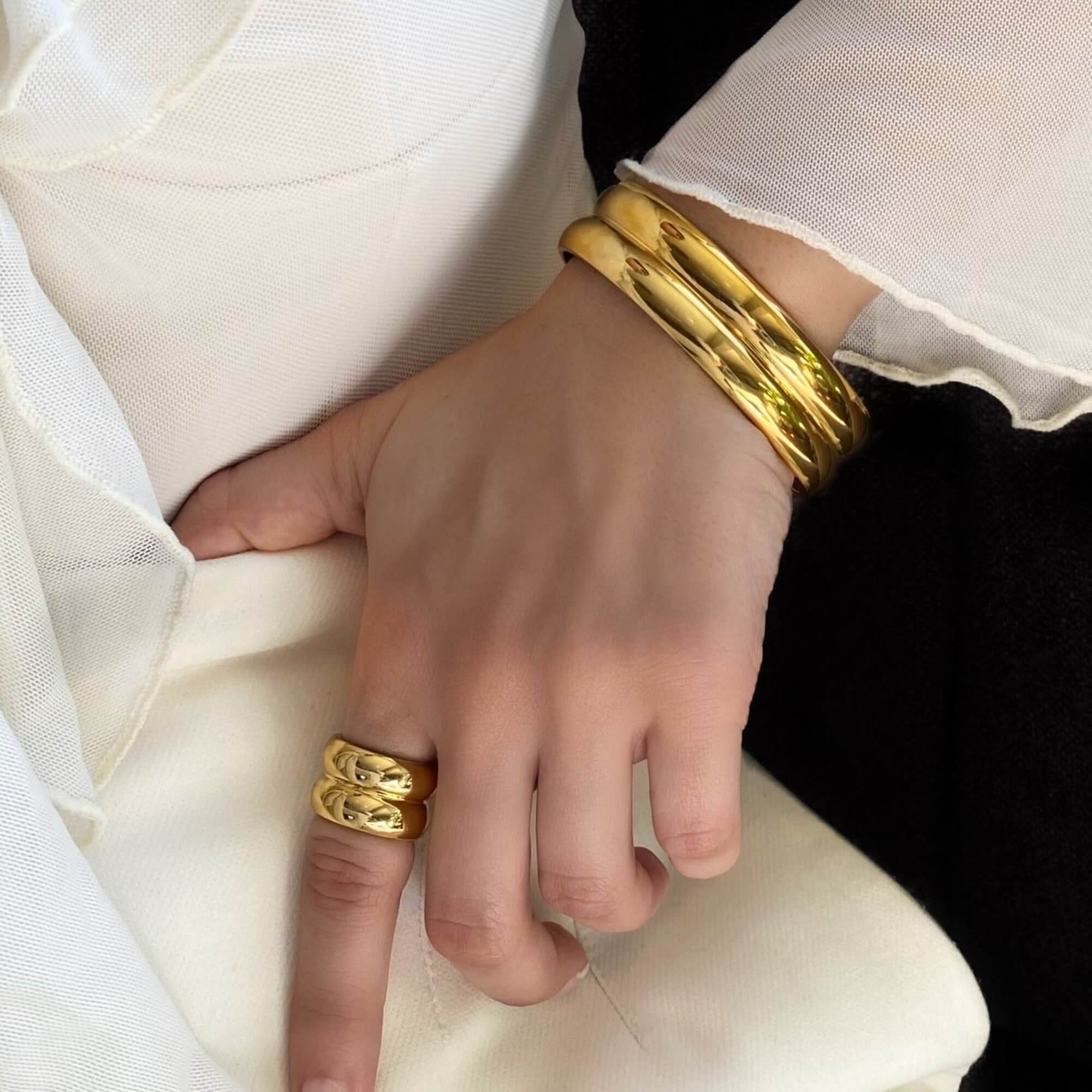 Angled view of the KinkoB 18K gold-plated bold bangle cuff bracelet by Kampy Designs, highlighting its thick and elegant gold-plated design.