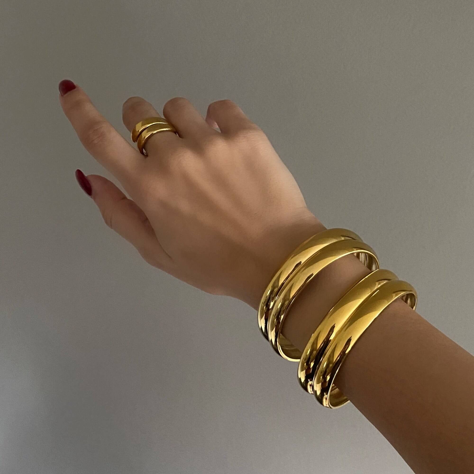 Close-up of the KinkoB 18K gold-plated bold bangle cuff bracelet by Kampy Designs, showcasing its high-polish finish and luxurious bold structure.
