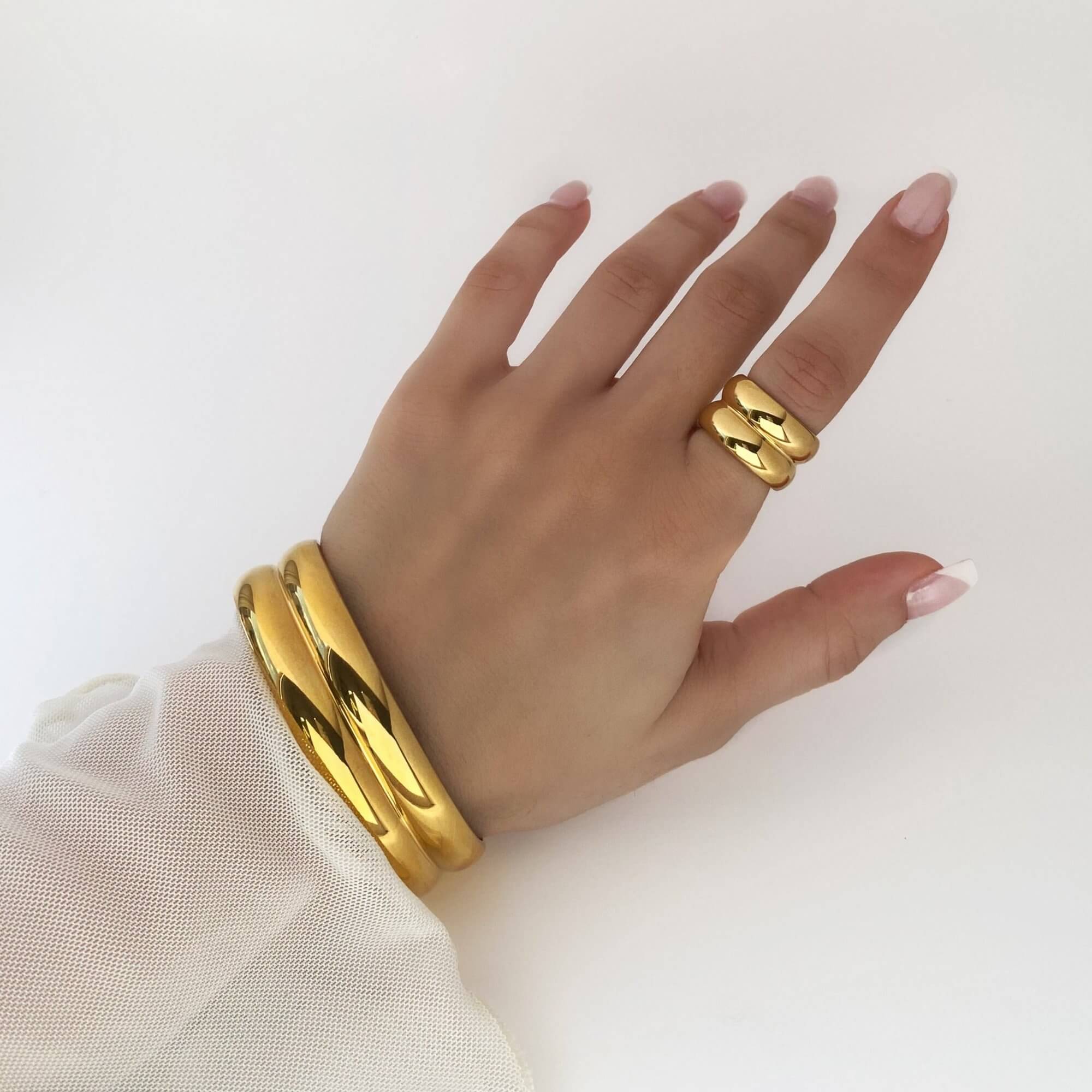 Side view of the KinkoB 18K gold-plated bold bangle cuff bracelet by Kampy Designs, emphasizing its thick, open-cuff style for a modern look.