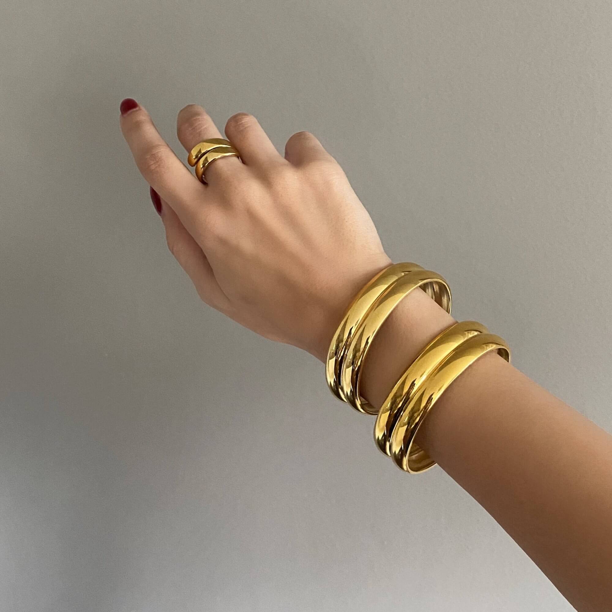 Stacked view of the KinkoB 18K gold-plated bold bangle cuff bracelet by Kampy Designs, layered with other bangles for a bold and trendy statement.