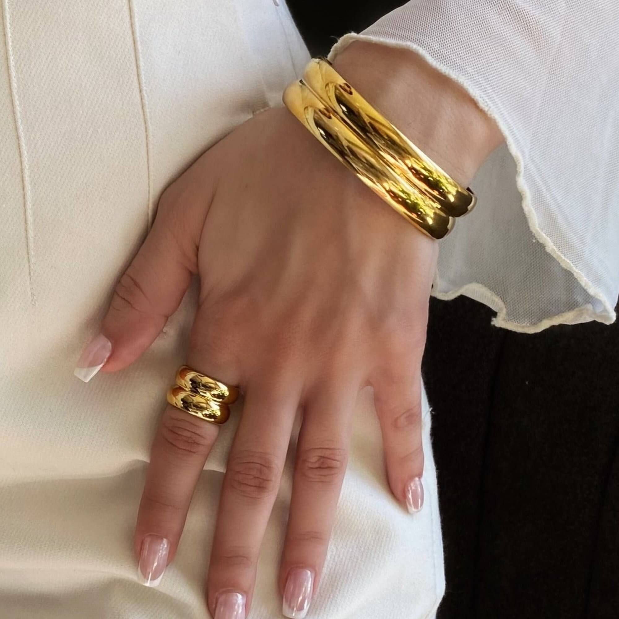 The KinkoB 18K gold-plated bold bangle cuff bracelet by Kampy Designs, styled elegantly for a chic and sophisticated jewelry look.