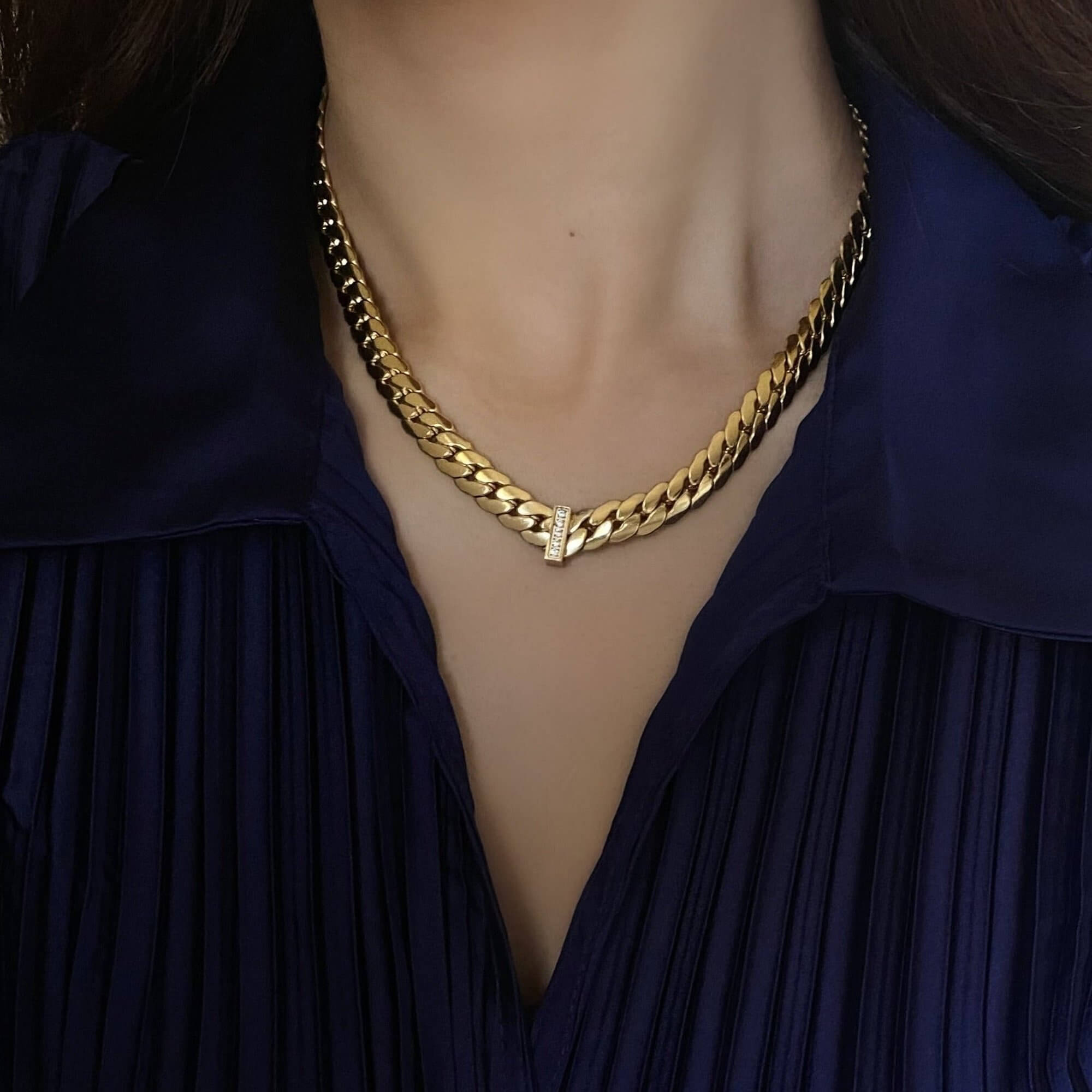 The KeikoN 18K gold-plated bold CZ necklace by Kampy Designs, styled with layering accessories to enhance its bold and elegant aesthetic.