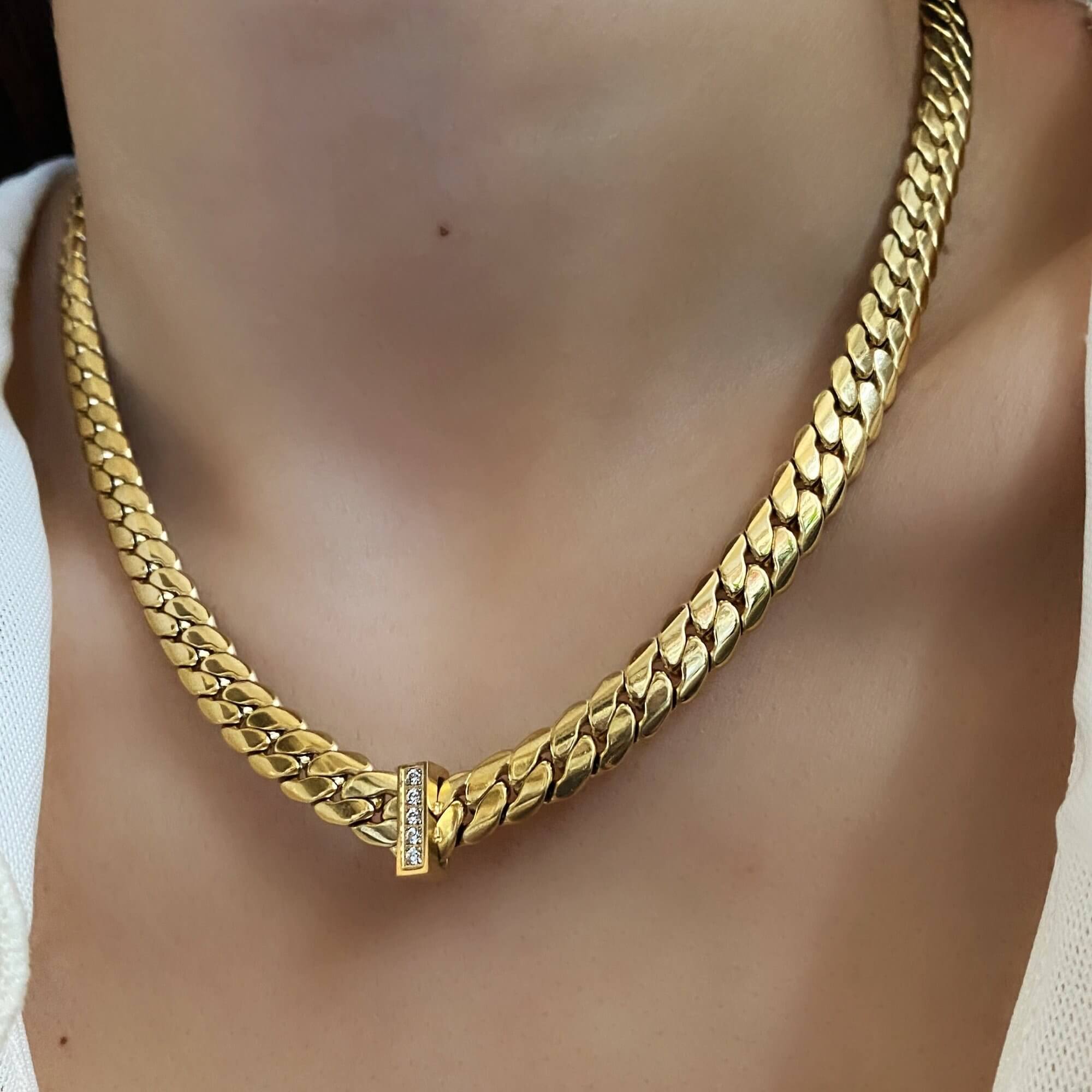 The KeikoN 18K gold-plated bold CZ necklace by Kampy Designs, elegantly worn to highlight its luxurious design and sparkling stones.