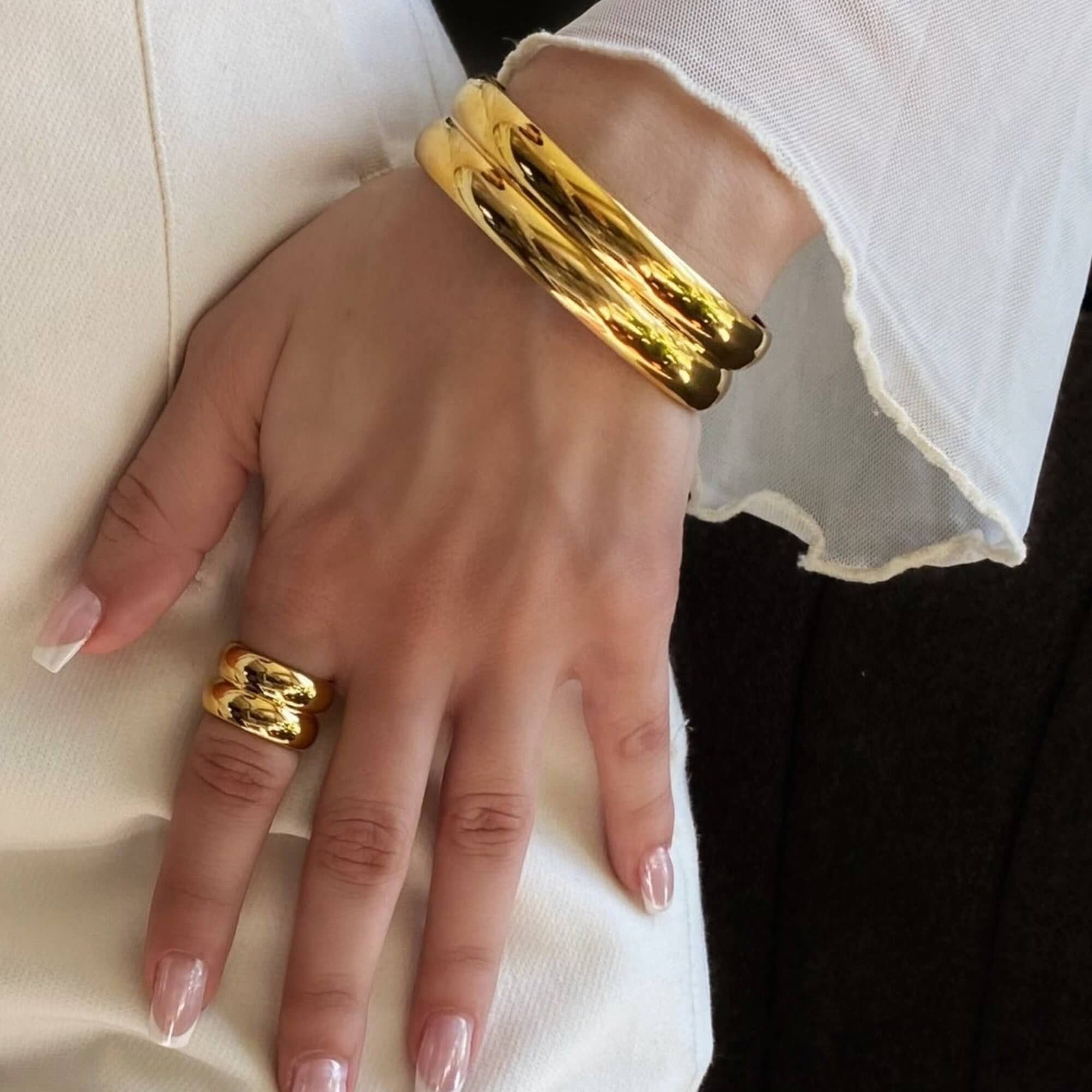 The KinkoR 18K gold-plated chunky bold ring by Kampy Designs, styled with other jewelry for a chic and elegant aesthetic.