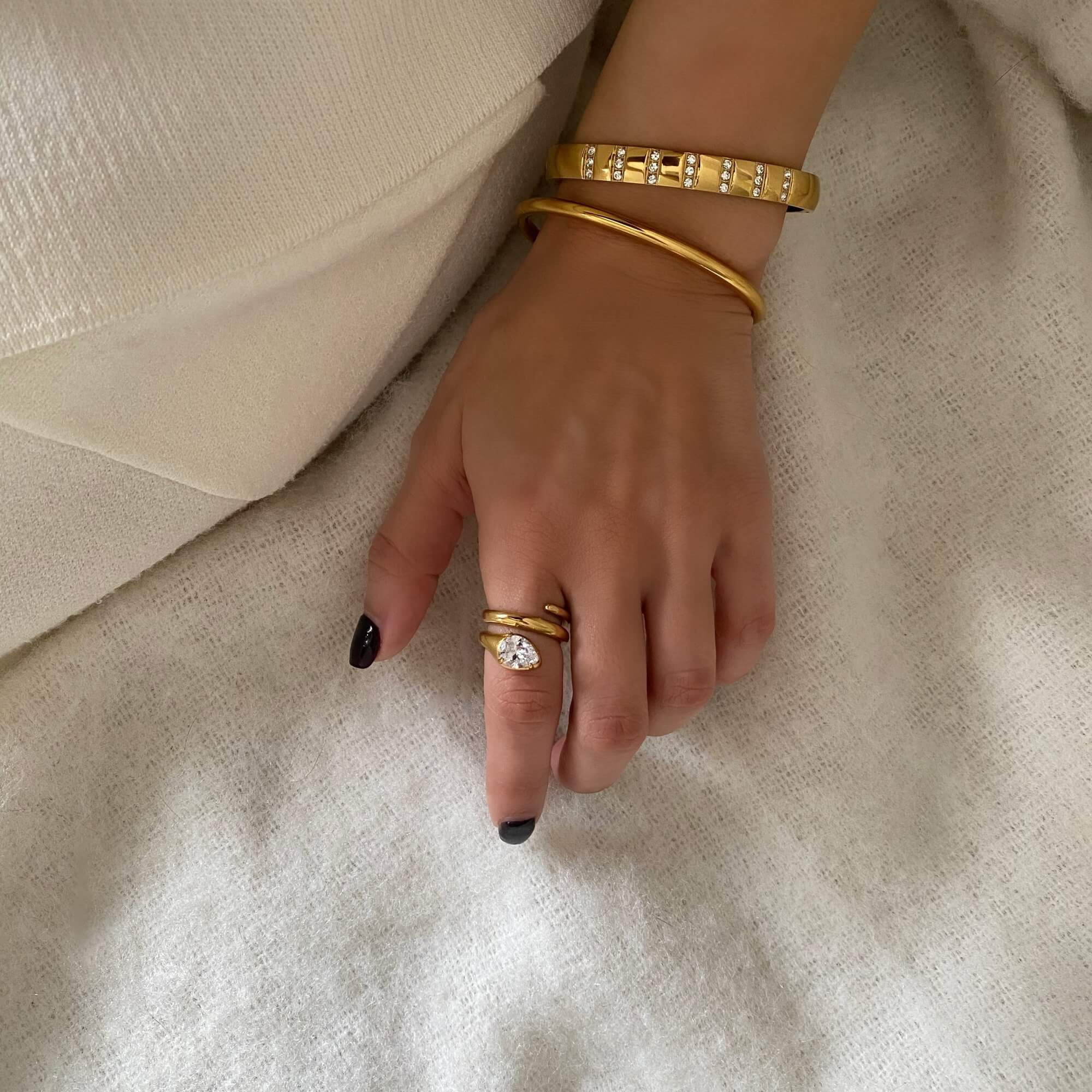 Full view of the KutesyB 18K gold-plated cuff bangle bracelet by Kampy Designs, stacked to emphasize its layering and elegant gold-tone.