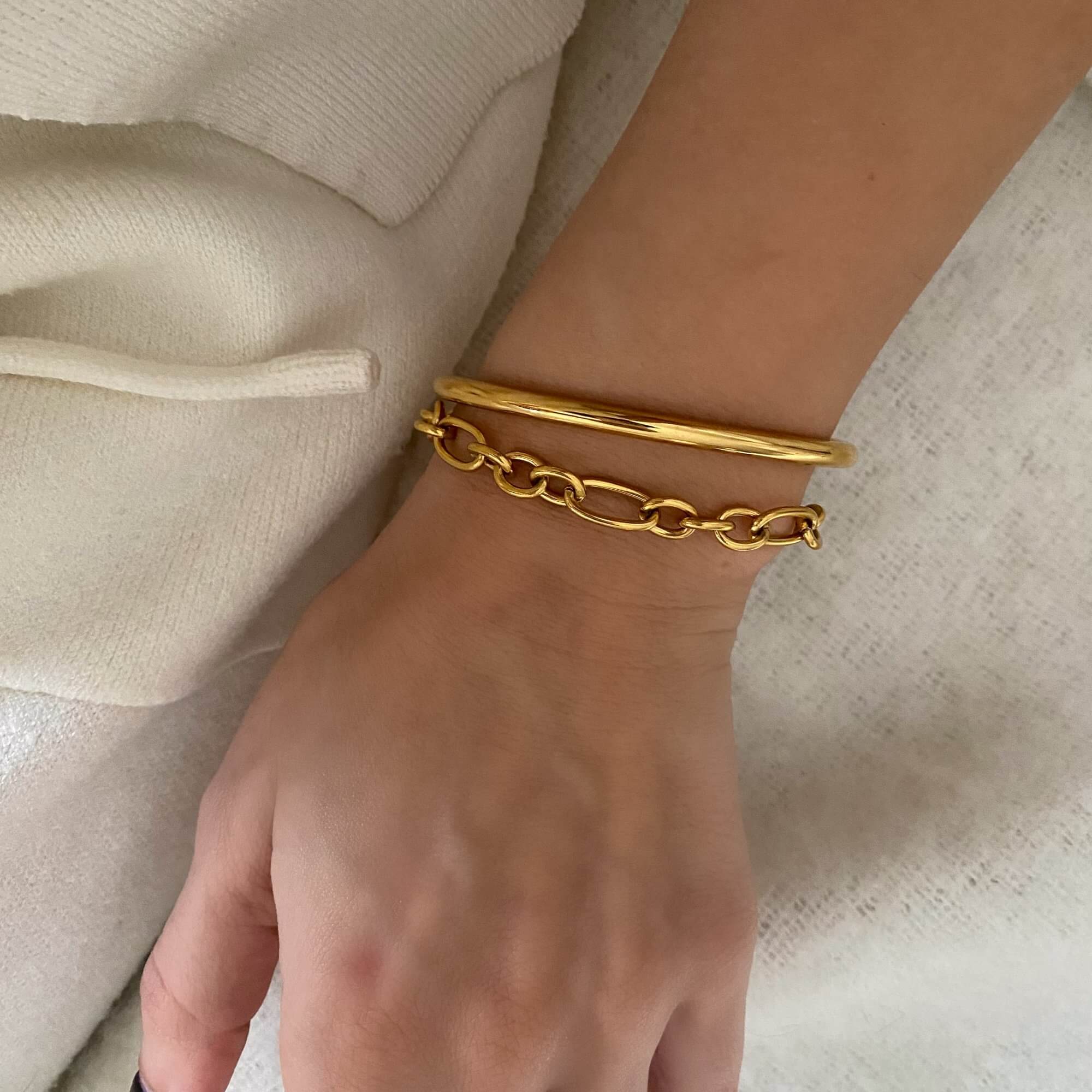 The KutesyB 18K gold-plated cuff bangle bracelet by Kampy Designs, elegantly stacked to showcase its sleek and modern design.