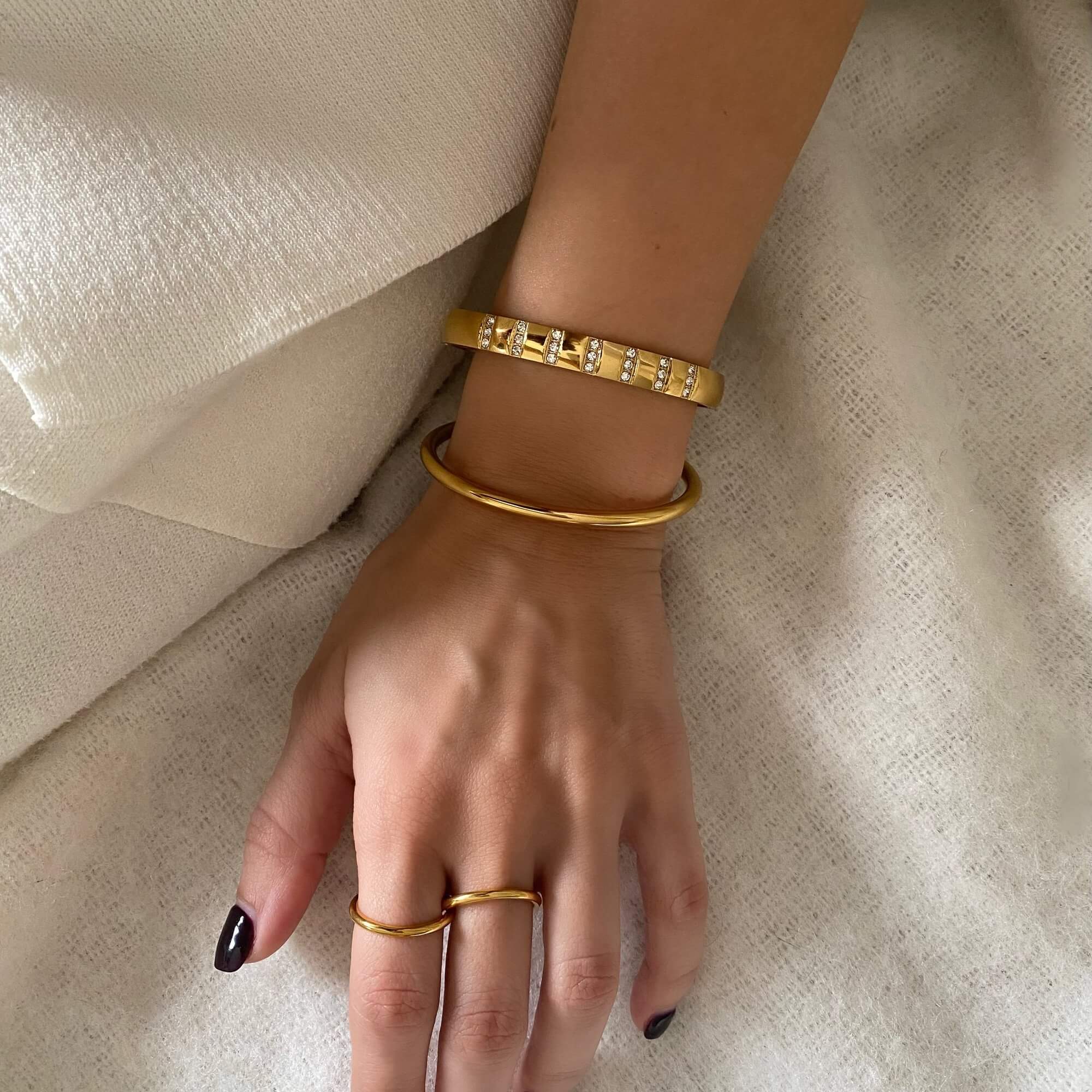 Top-down view of the KutesyB 18K gold-plated cuff bangle bracelet by Kampy Designs, showcasing its polished surface and delicate curvature.