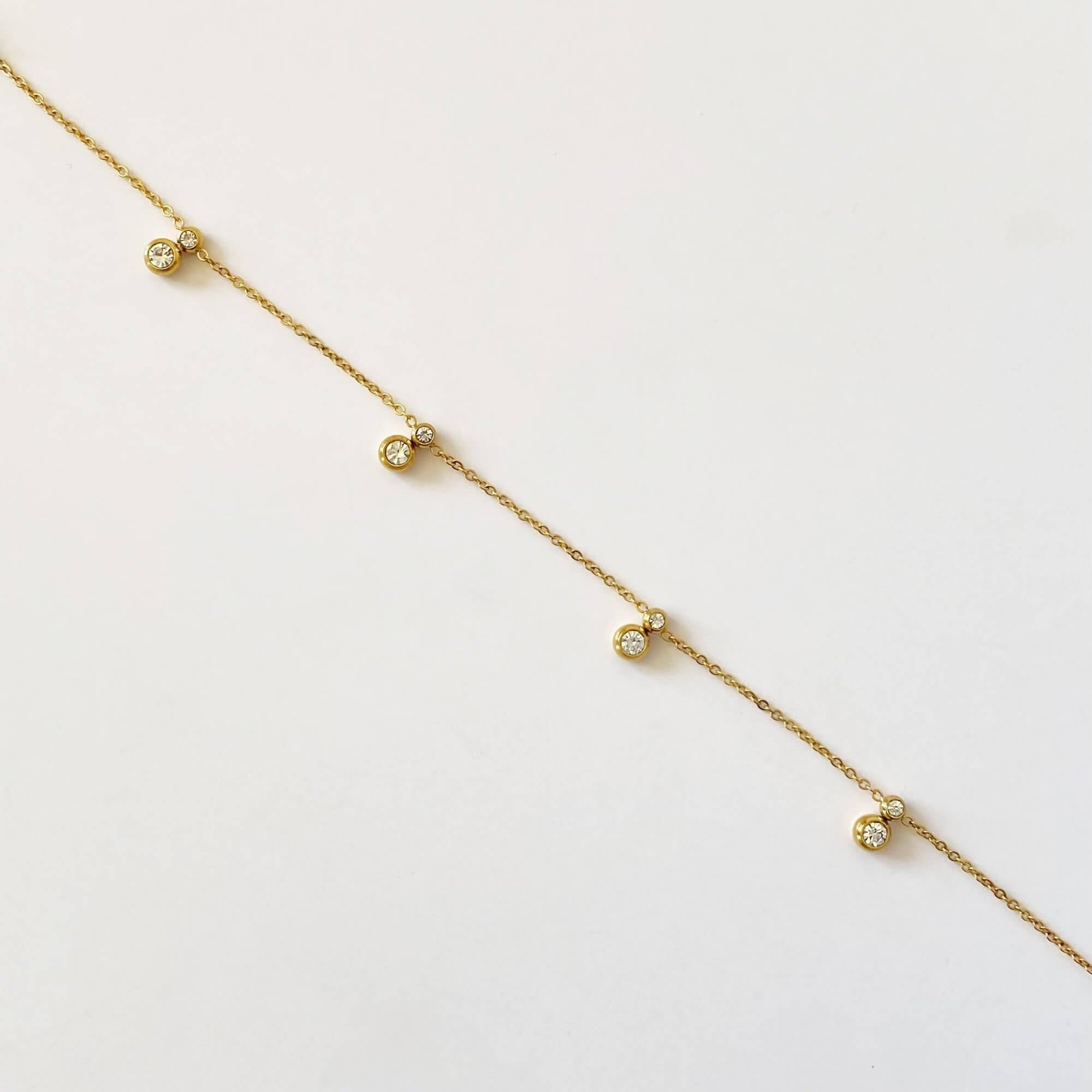 Alternative front views of the KibB 18K gold-plated CZ charm anklet by Kampy Designs, displaying its elegant charm details and luxurious craftsmanship from different perspectives.