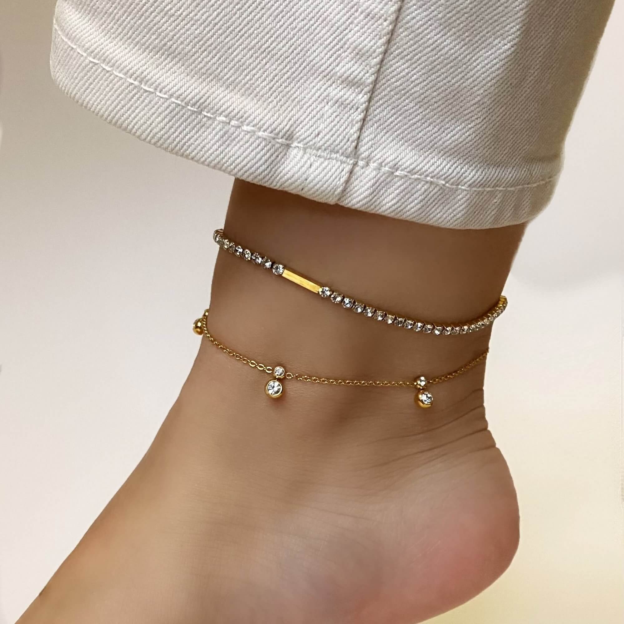 Angled view of the KarB 18K gold-plated CZ tennis anklet by Kampy Designs, emphasizing its shimmering stone placement and delicate gold chain.