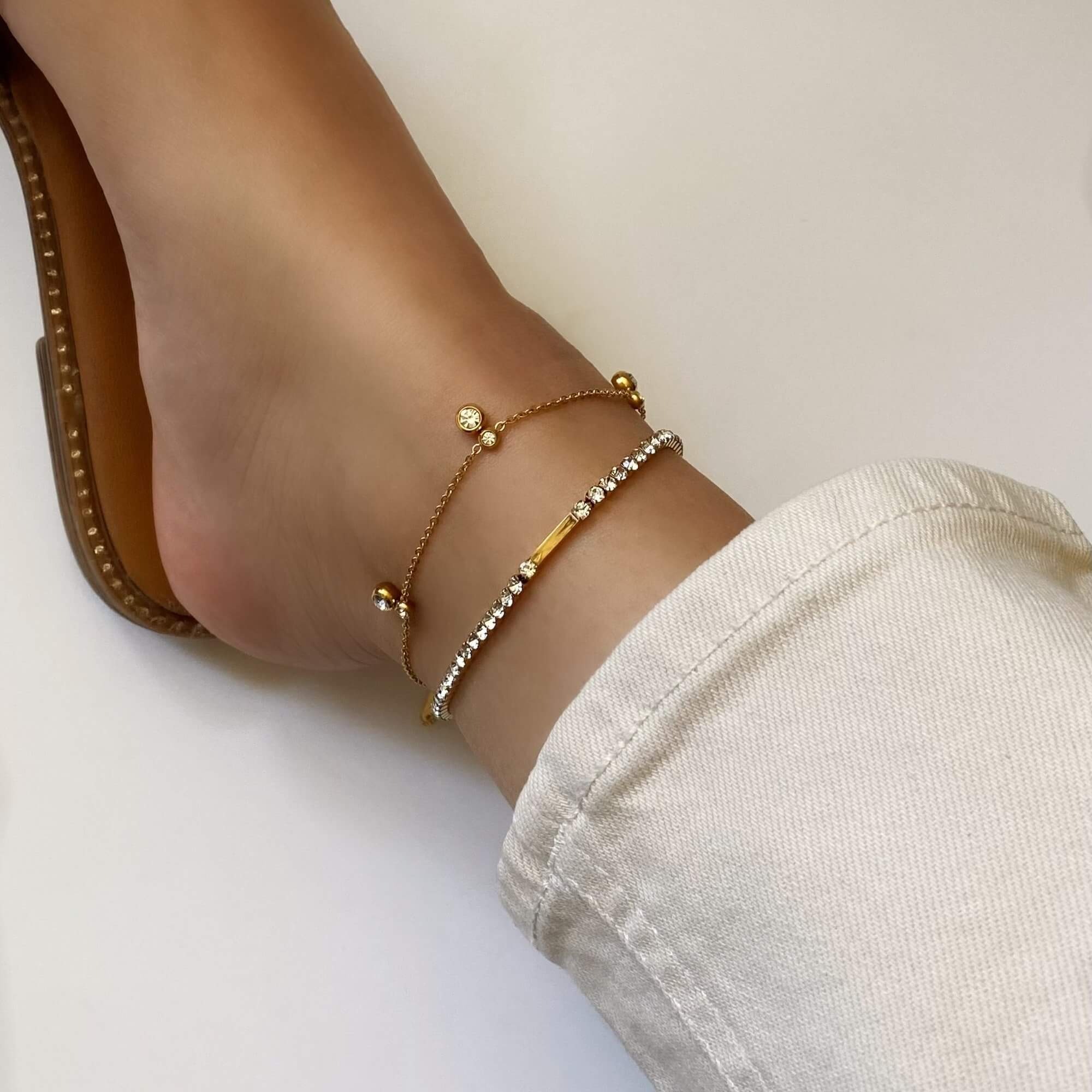 Side view of the KarB 18K gold-plated CZ tennis anklet by Kampy Designs, displaying its sleek silhouette and radiant sparkle.