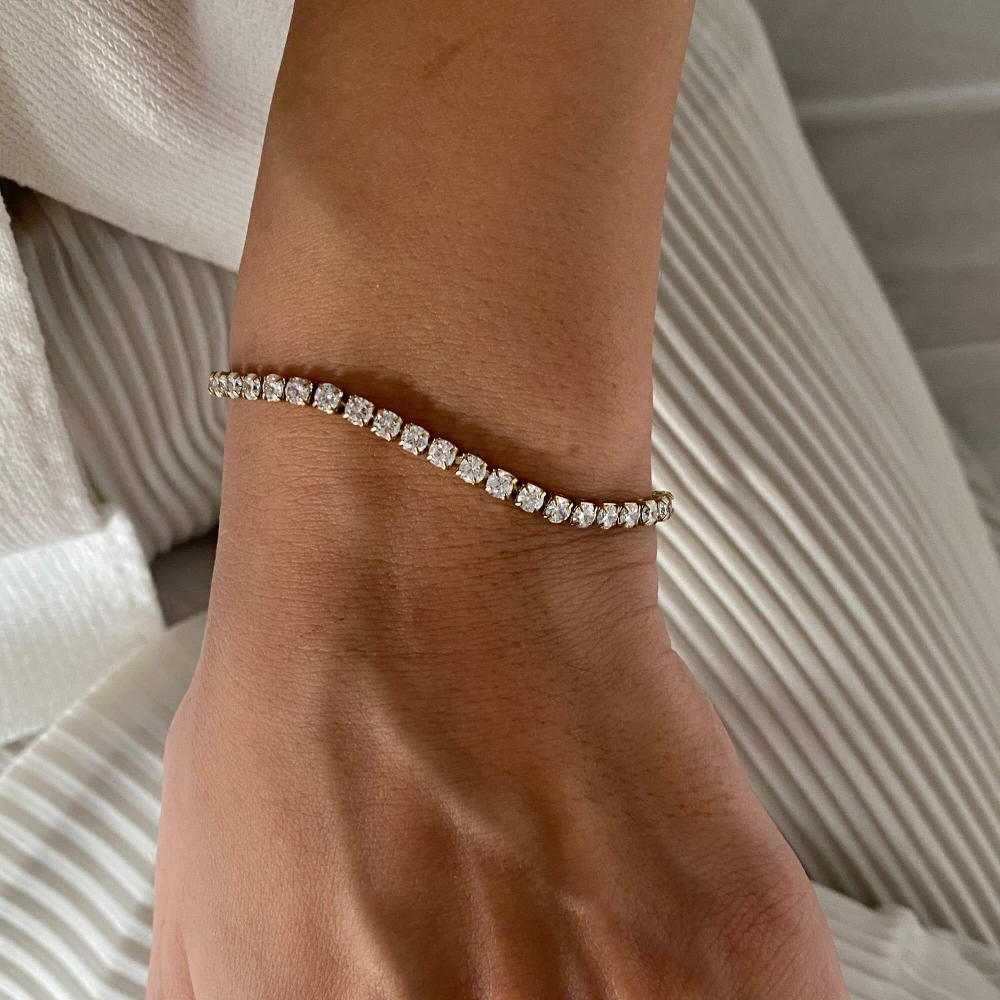 Top-down view of the KennisB 18K gold-plated CZ tennis bracelet by Kampy Designs, showcasing its elegant row of sparkling cubic zirconia stones.