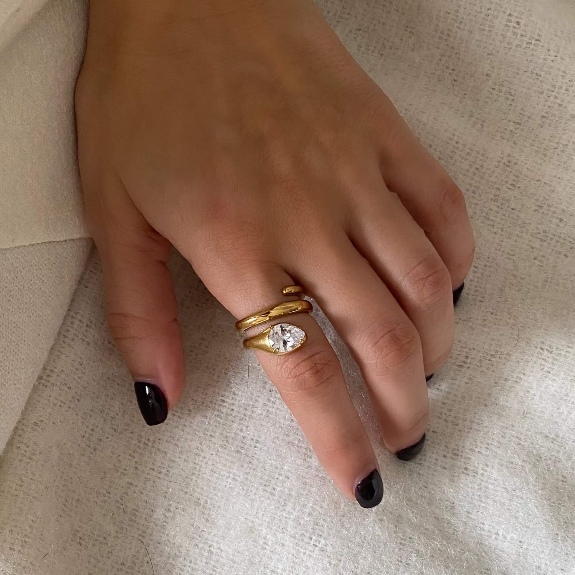 The KinderR 18K gold-plated diamond serpent ring by Kampy Designs, worn on a hand, displaying its luxurious and bold design.