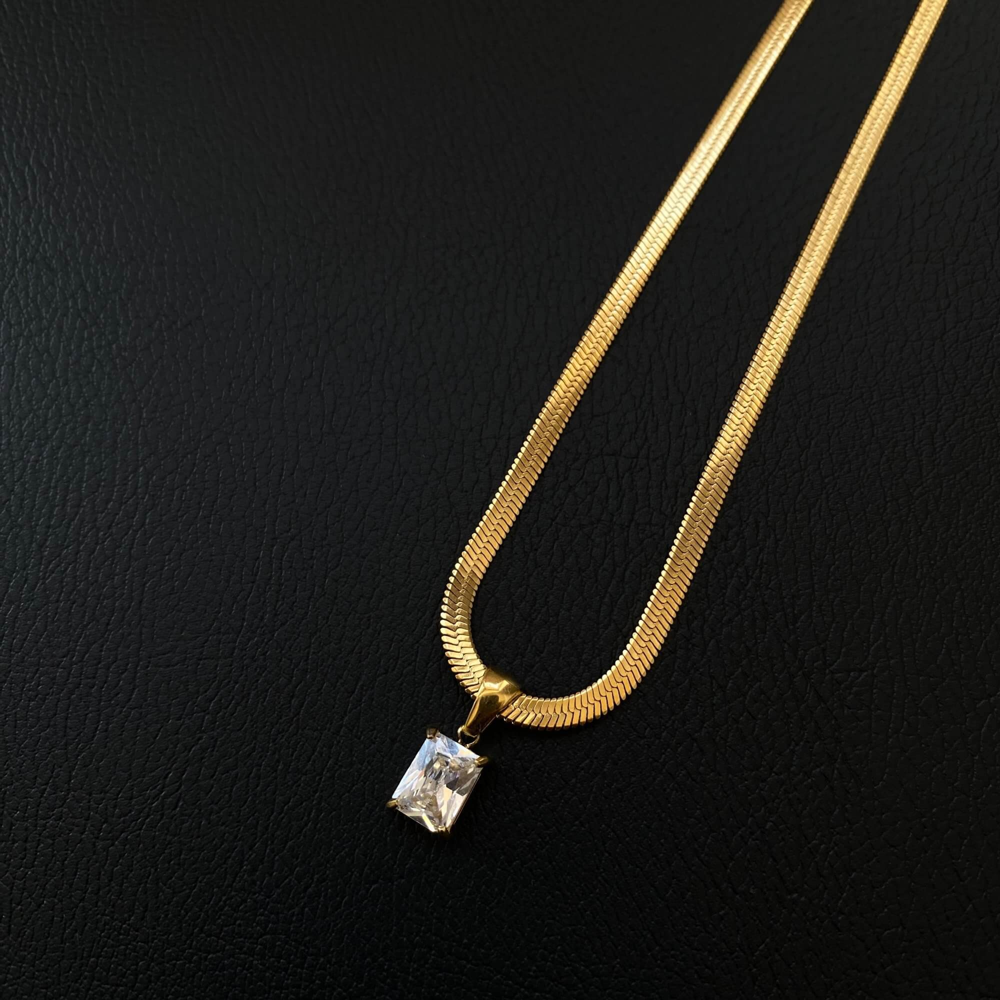 Angled view of the KonokoN 18K gold-plated emerald-cut CZ pendant necklace by Kampy Designs, capturing its stunning facets and elegant chain.