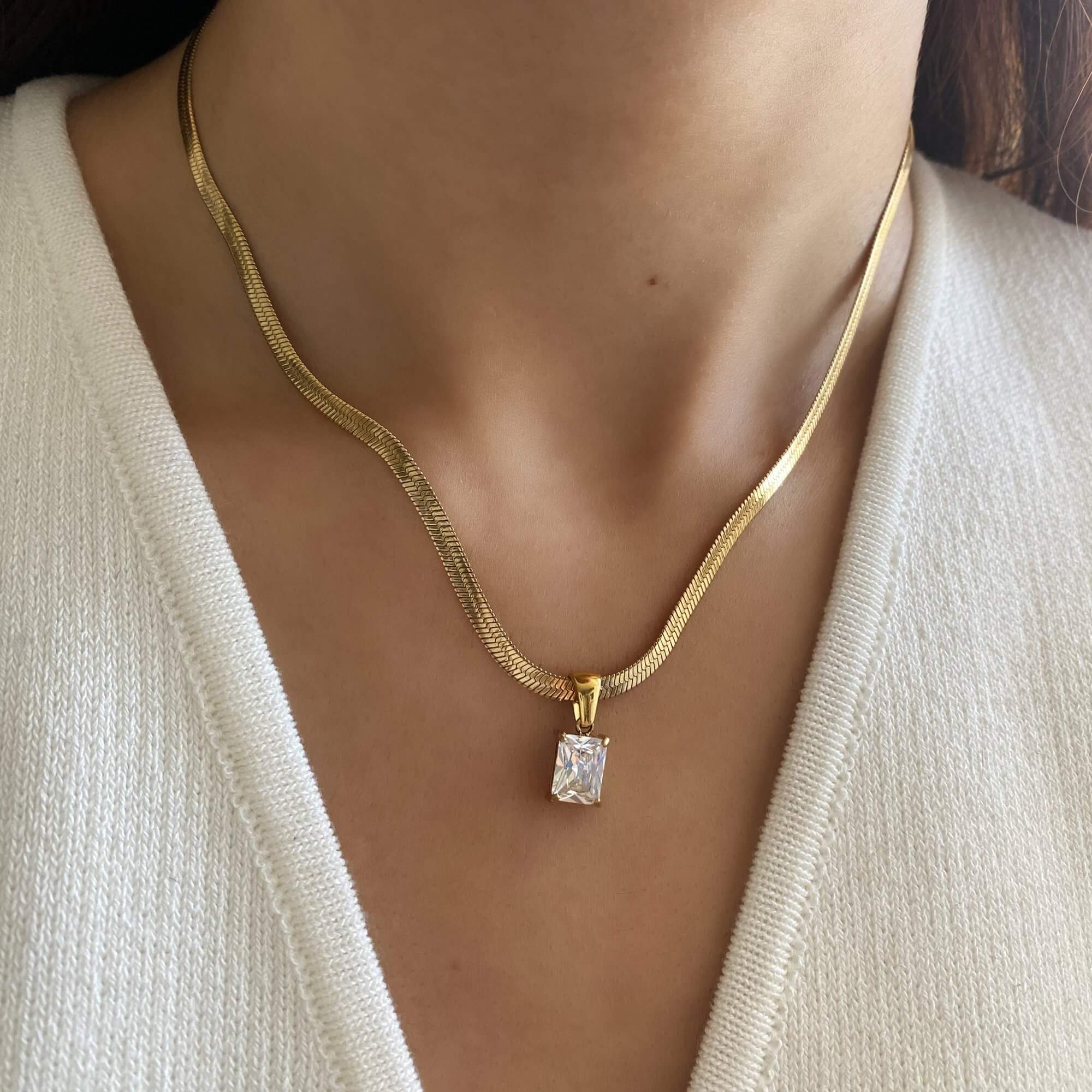 The KonokoN 18K gold-plated emerald-cut CZ pendant necklace by Kampy Designs, elegantly worn to showcase its refined sparkle and classic style