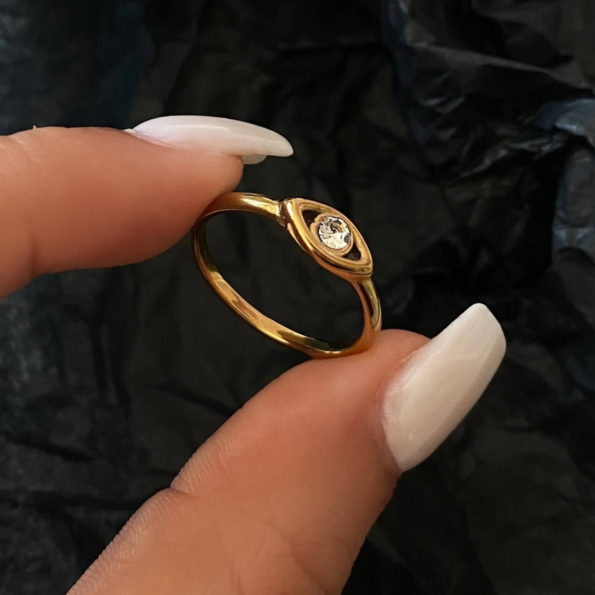 Angled view of the KanakaR 18K gold-plated evil eye stone ring by Kampy Designs, displaying its radiant gold finish and striking gemstone centerpiece.