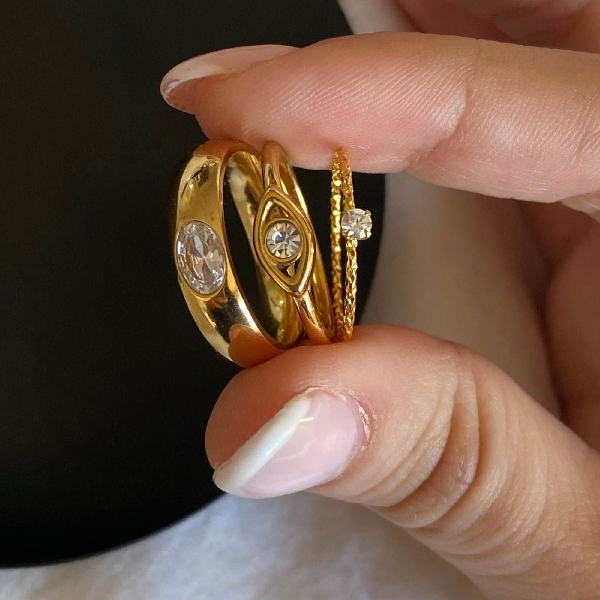 Stacked view of the KanakaR 18K gold-plated evil eye stone ring by Kampy Designs, layered with other rings for a stylish and meaningful look.