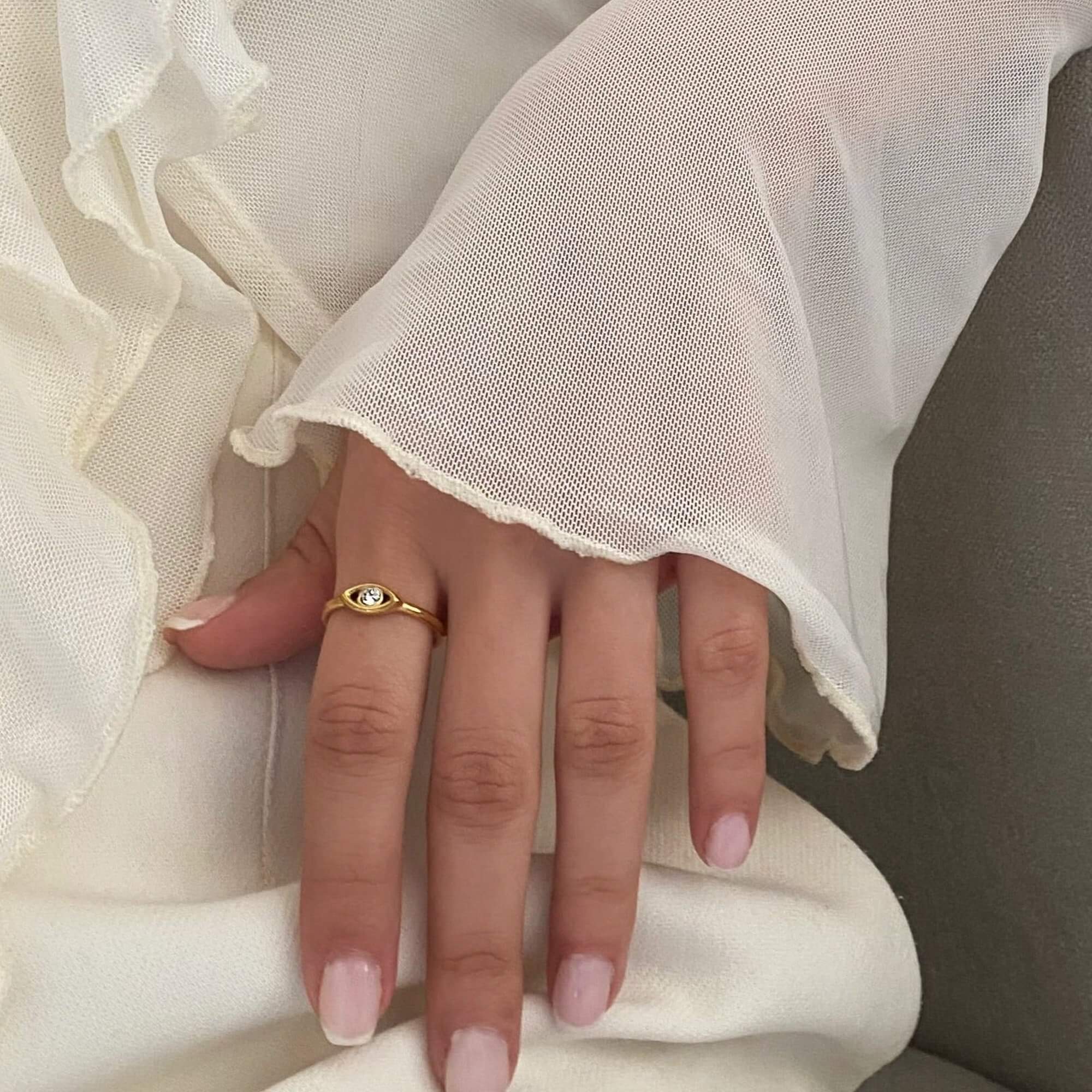 The KanakaR 18K gold-plated evil eye stone ring by Kampy Designs, worn on the hand to highlight its spiritual significance and modern elegance.