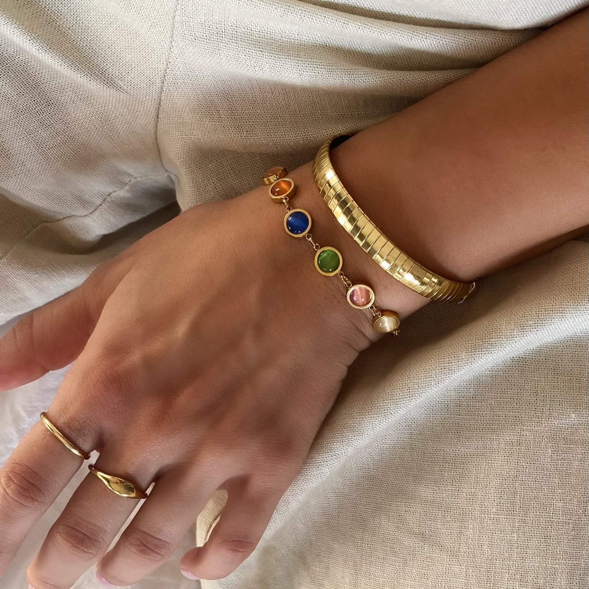 Angled view of the KenyaB 18K gold-plated flat gold bracelet (7mm) by Kampy Designs, showcasing its smooth finish and elegant design.