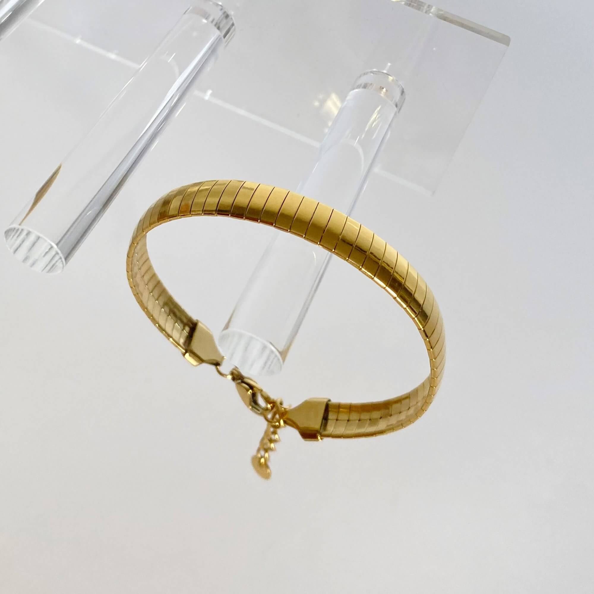 Close-up of the KenyaB 18K gold-plated flat gold bracelet (7mm) by Kampy Designs, highlighting its polished texture and high-quality craftsmanship.