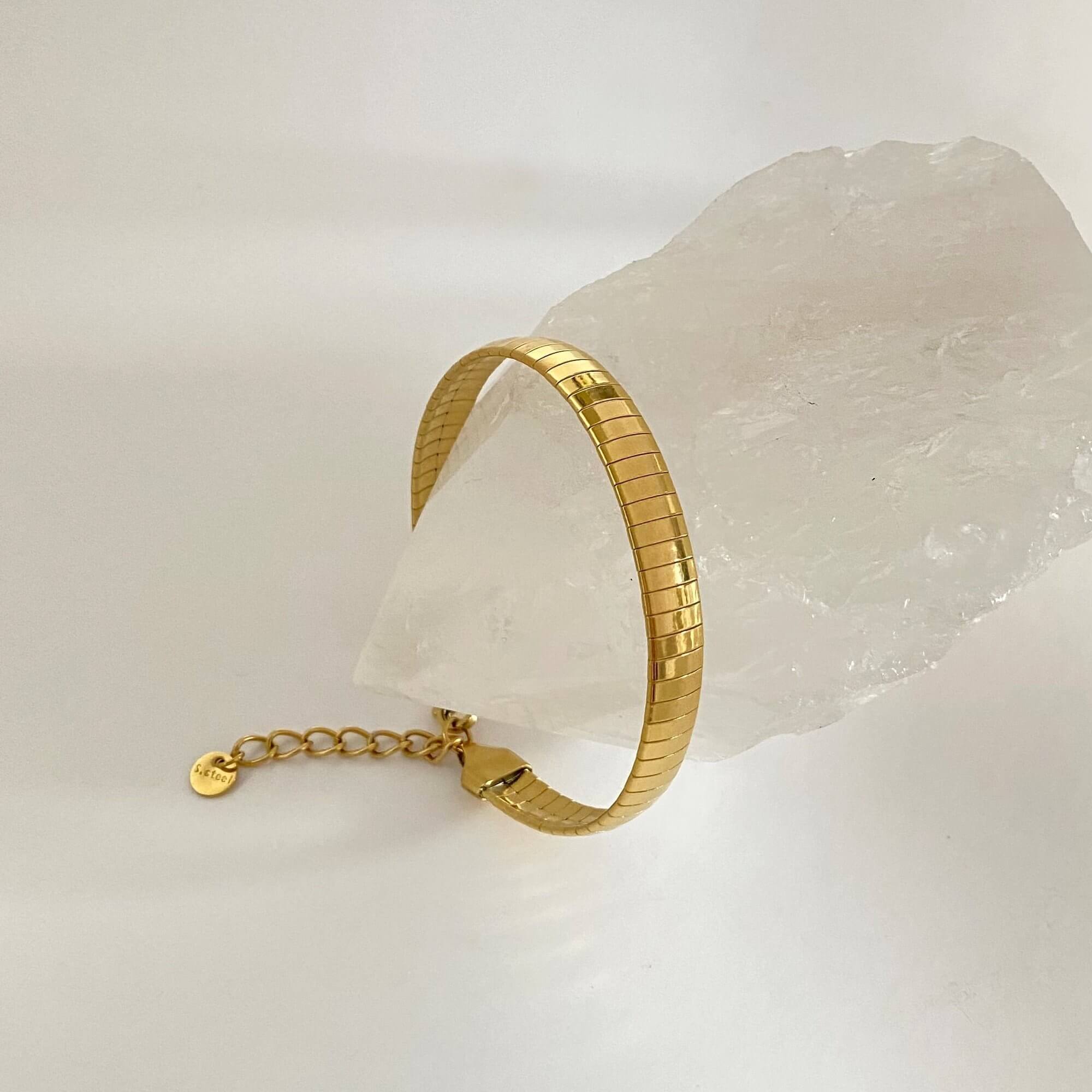 Side view of the KenyaB 18K gold-plated flat gold bracelet (7mm) by Kampy Designs, capturing its elegant and smooth gold finish.