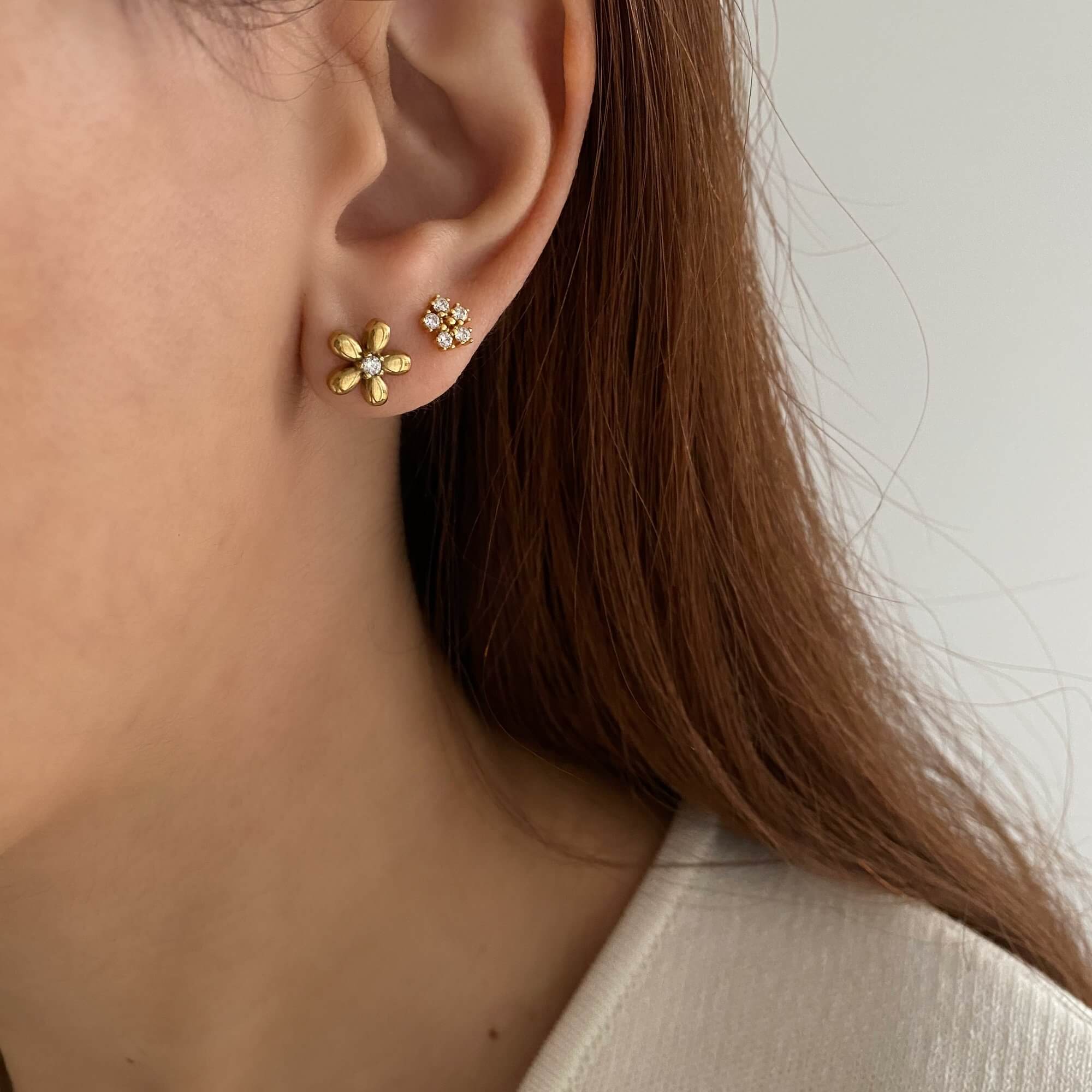 Close-up view of the KayleyE 18K gold-plated flower stud earrings by Kampy Designs, showcasing intricate floral detailing and polished finish.