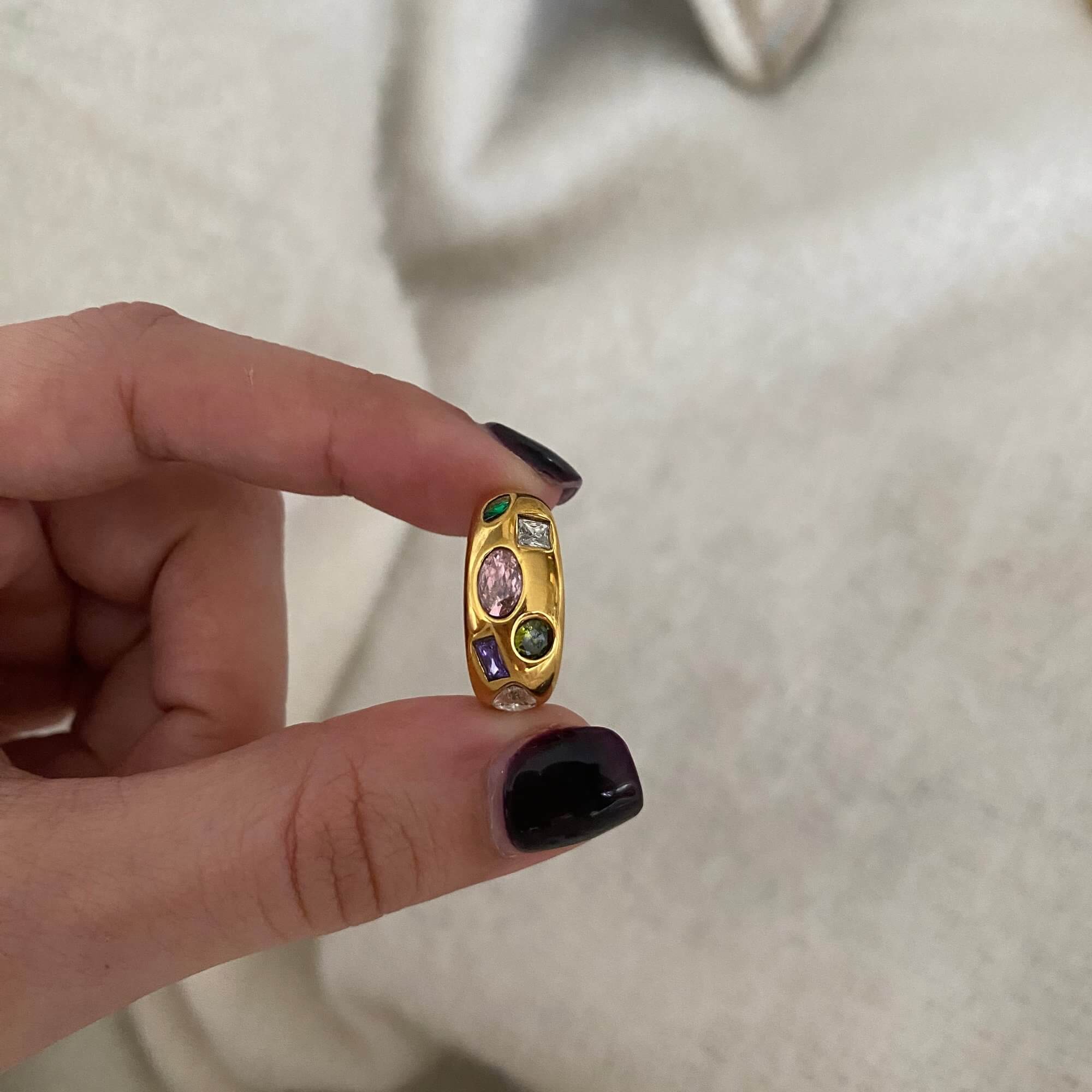 The KemmaR 18K gold-plated gemstone dome ring by Kampy Designs, held in hand to highlight its size and luxurious gold finish.