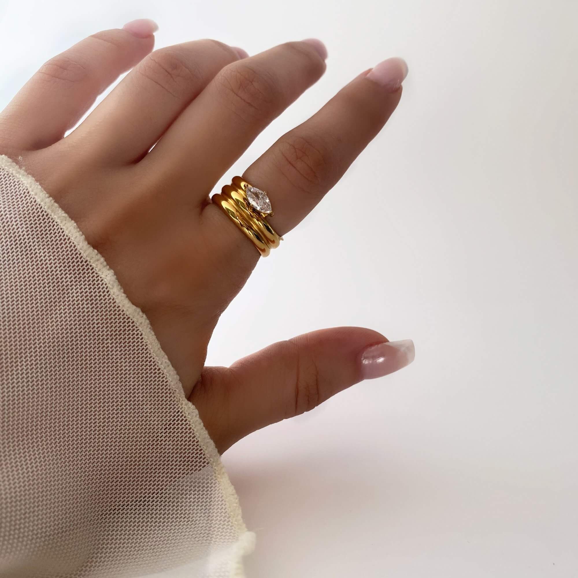 Angled view of the KimchiR 18K gold-plated marquise-cut wrap ring by Kampy Designs, showcasing its sleek wrap-around band and elegant marquise-cut gemstones.