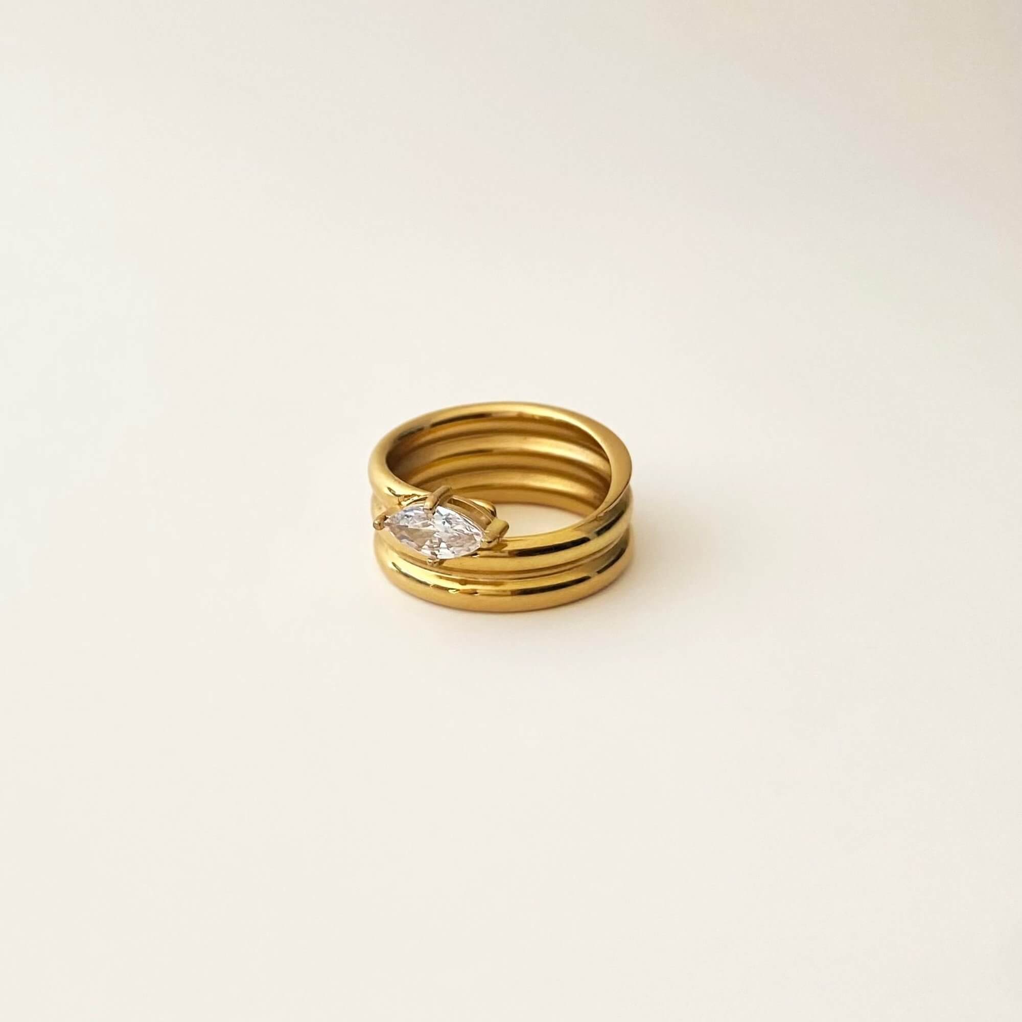 Side view of the KimchiR 18K gold-plated marquise-cut wrap ring by Kampy Designs, emphasizing its curved wrap style and refined gold finish.