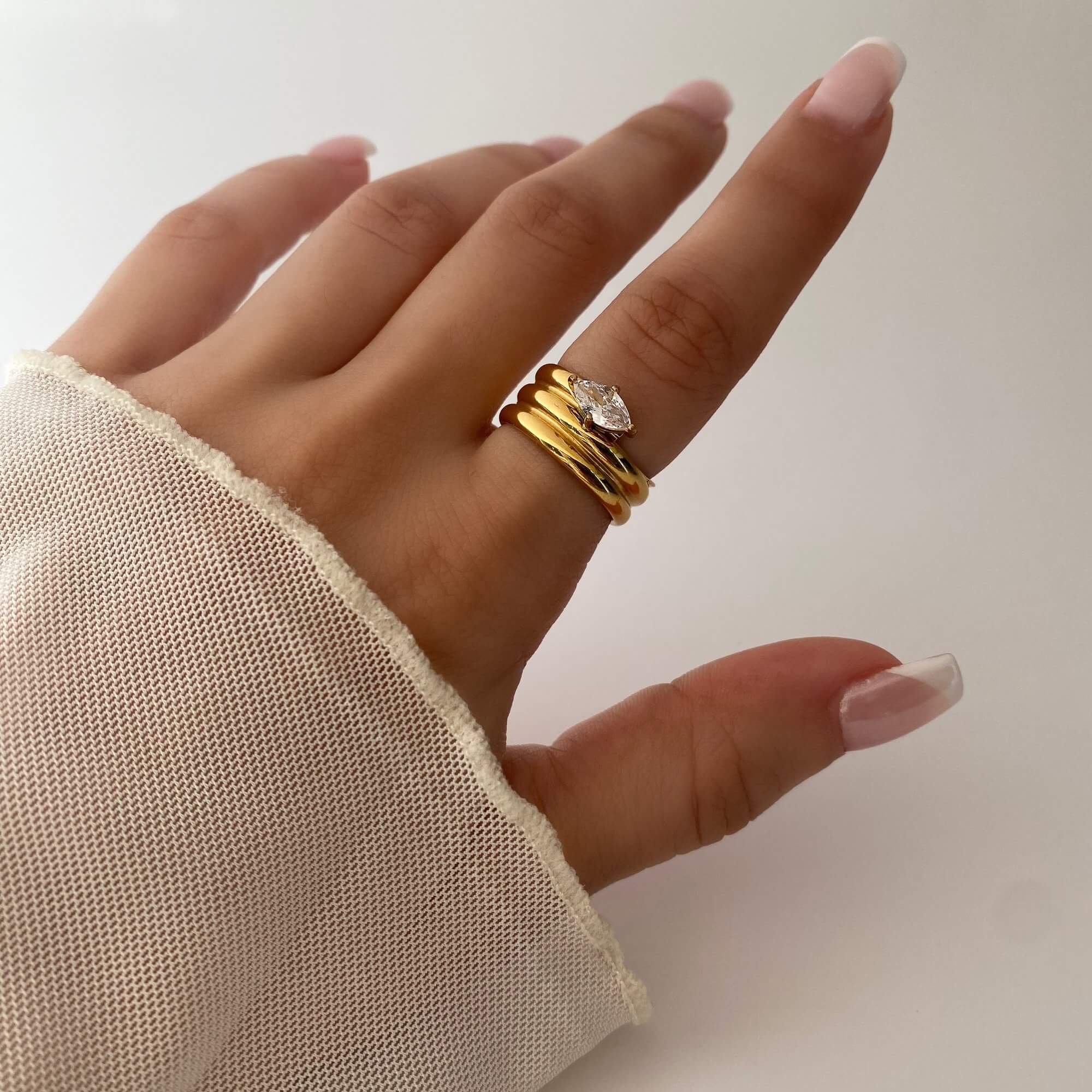 The KimchiR 18K gold-plated marquise-cut wrap ring by Kampy Designs, worn to showcase its graceful wrap design and luxurious shine.