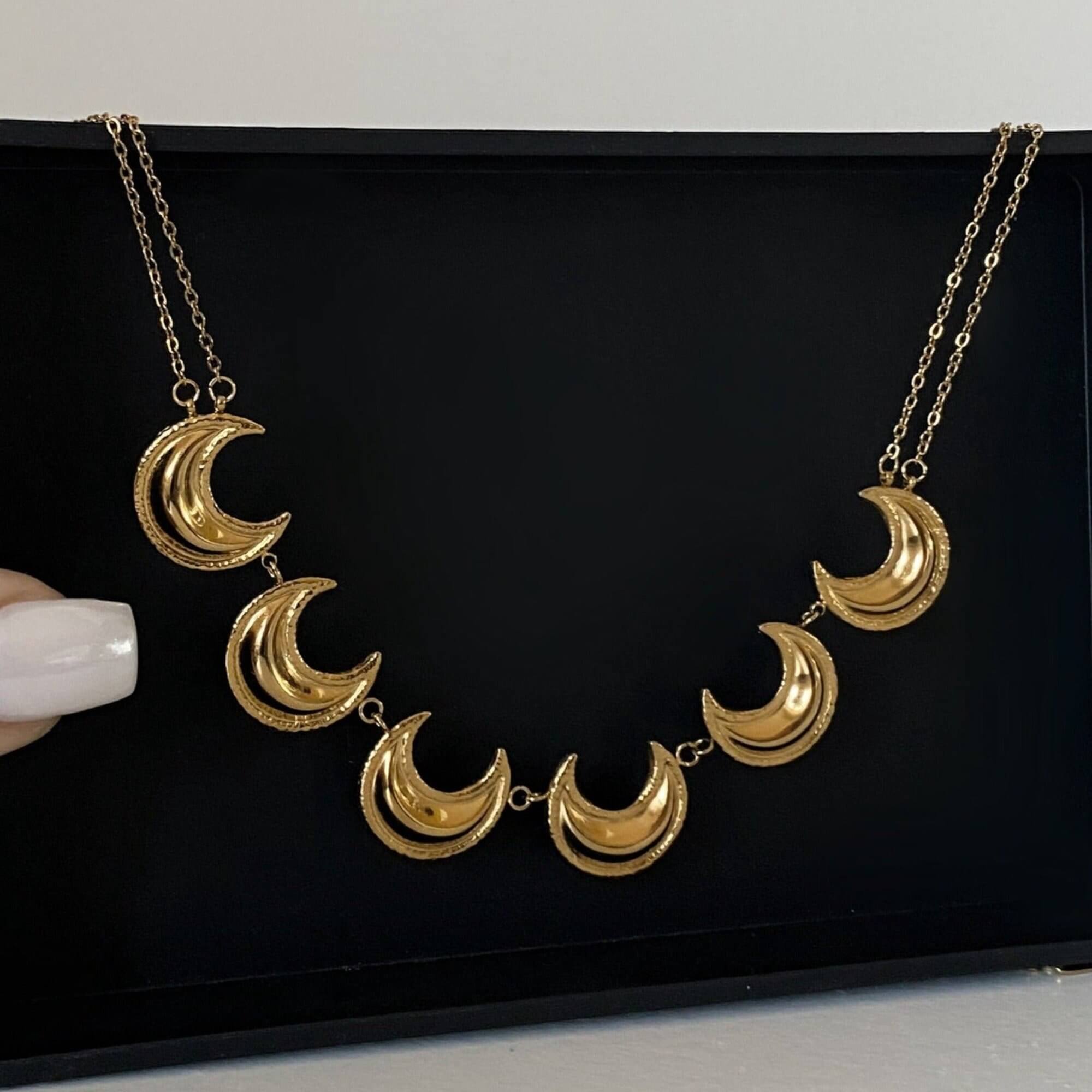Front view of the KrescentN 18K gold-plated moon charm choker necklace by Kampy Designs, featuring an elegant crescent moon charm and shimmering gold-plated finish.