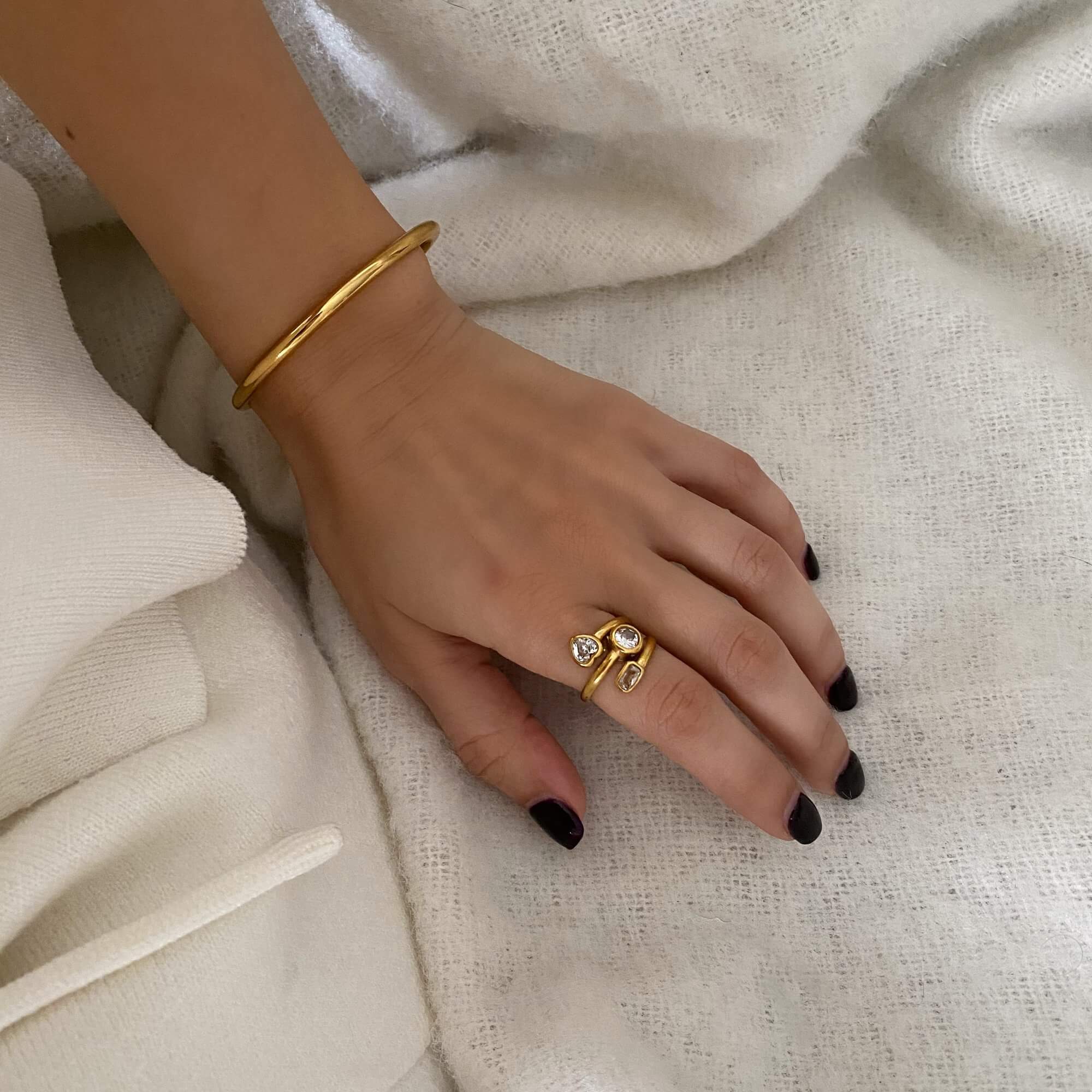 Angled view of the KastleR 18K gold-plated multi-stone spiral ring by Kampy Designs, capturing its unique curvature and radiant gemstone details.
