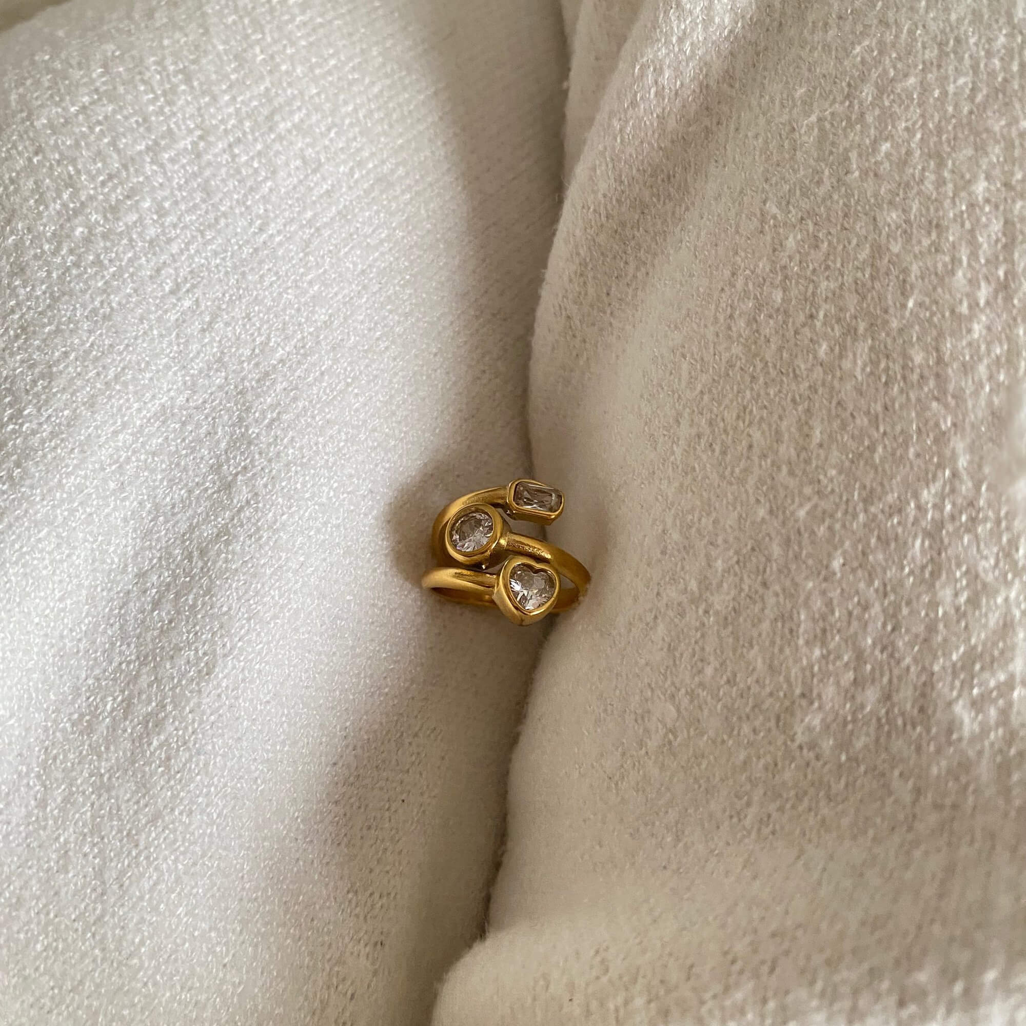 Front view of the KastleR 18K gold-plated multi-stone spiral ring by Kampy Designs, highlighting its bold and luxurious design with a shimmering multi-stone setting.