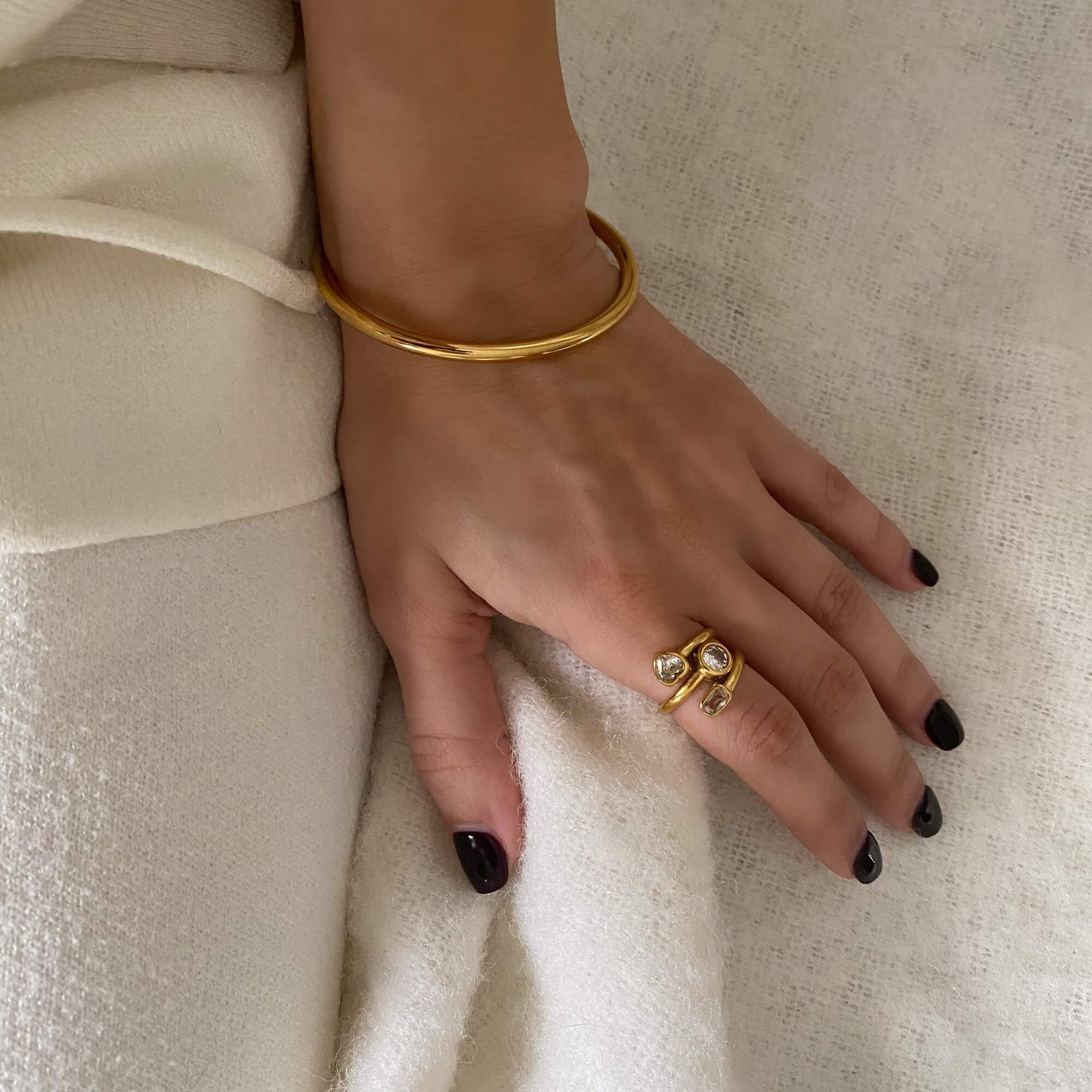 Side view of the KastleR 18K gold-plated multi-stone spiral ring by Kampy Designs, showcasing its elegant curved design and sparkling gemstones.