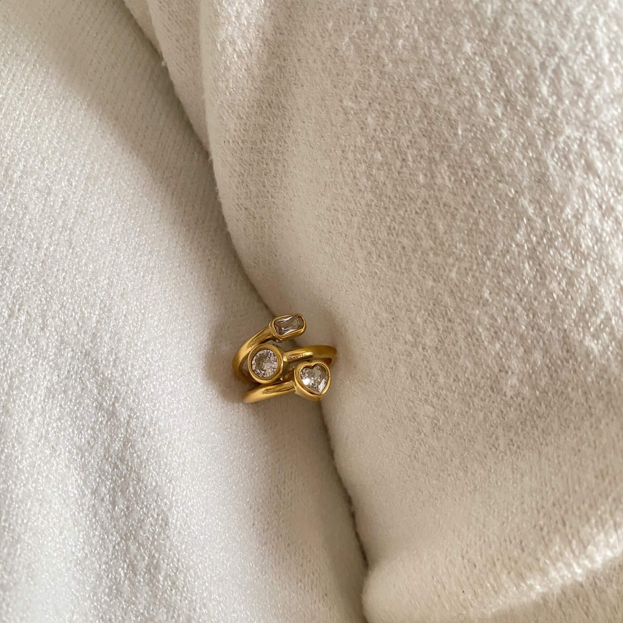 Top-down view of the KastleR 18K gold-plated multi-stone spiral ring by Kampy Designs, emphasizing the intricate arrangement of gemstones in a spiral pattern.