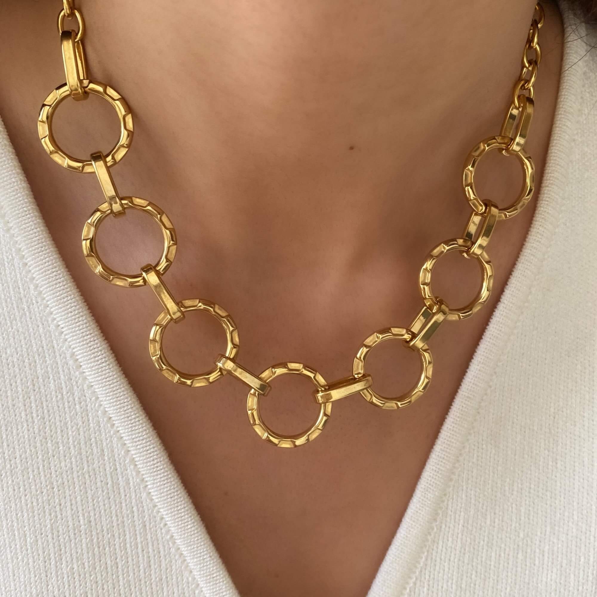Close-up of the KostyN 18K gold-plated open circle charm necklace by Kampy Designs, highlighting its detailed charm and shimmering gold finish.