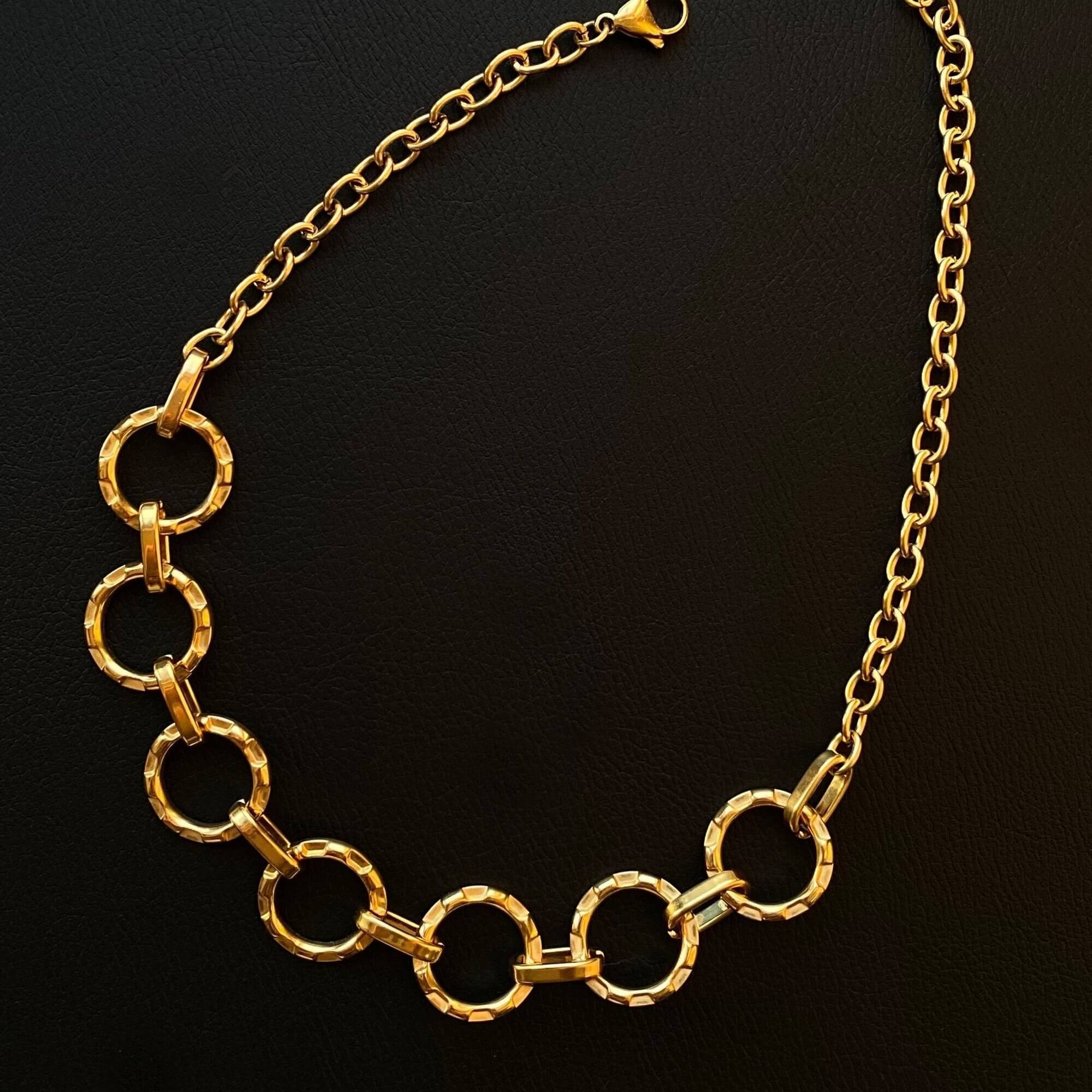 Top-down view of the KostyN 18K gold-plated open circle charm necklace by Kampy Designs, showcasing its lightweight and elegant design.