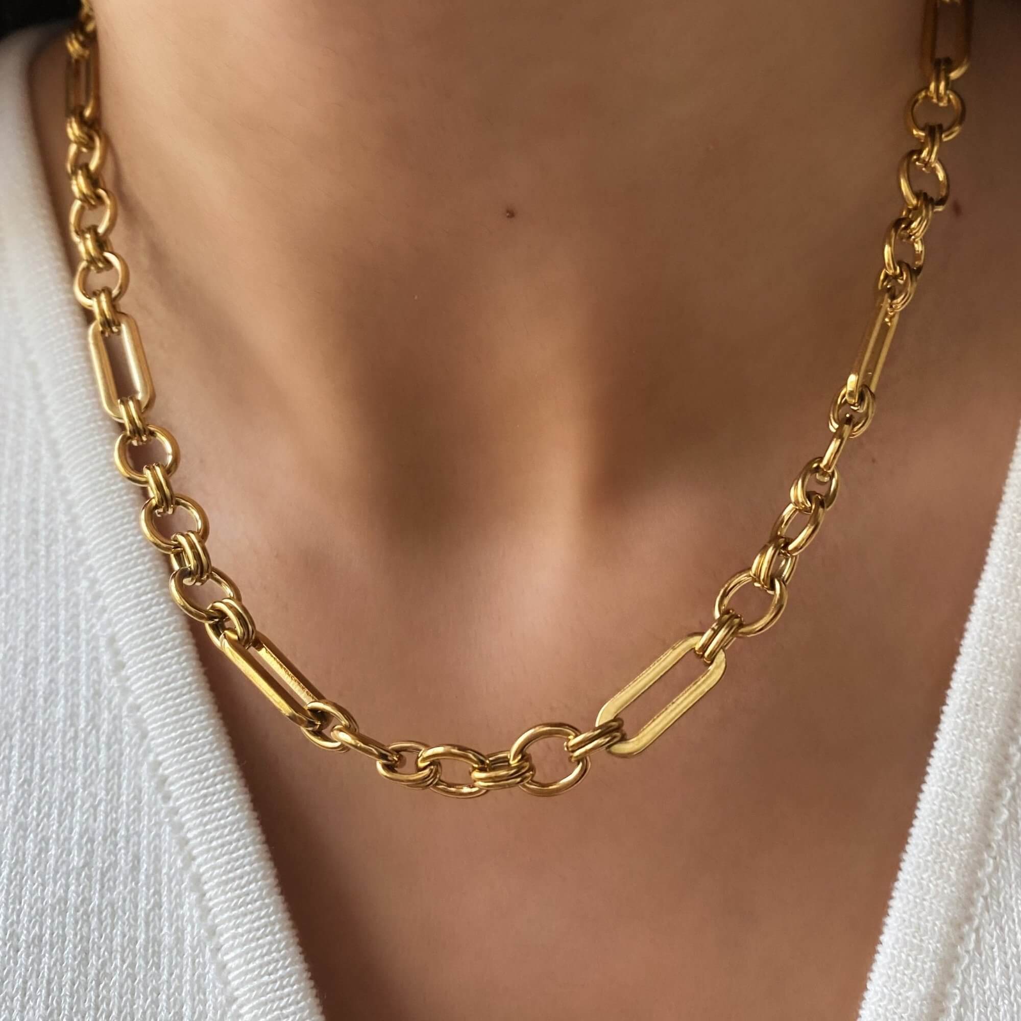 Dangle view of the KinnN 18K gold-plated paperclip link chain choker necklace by Kampy Designs, showcasing its sleek, modern design with interlocking links.