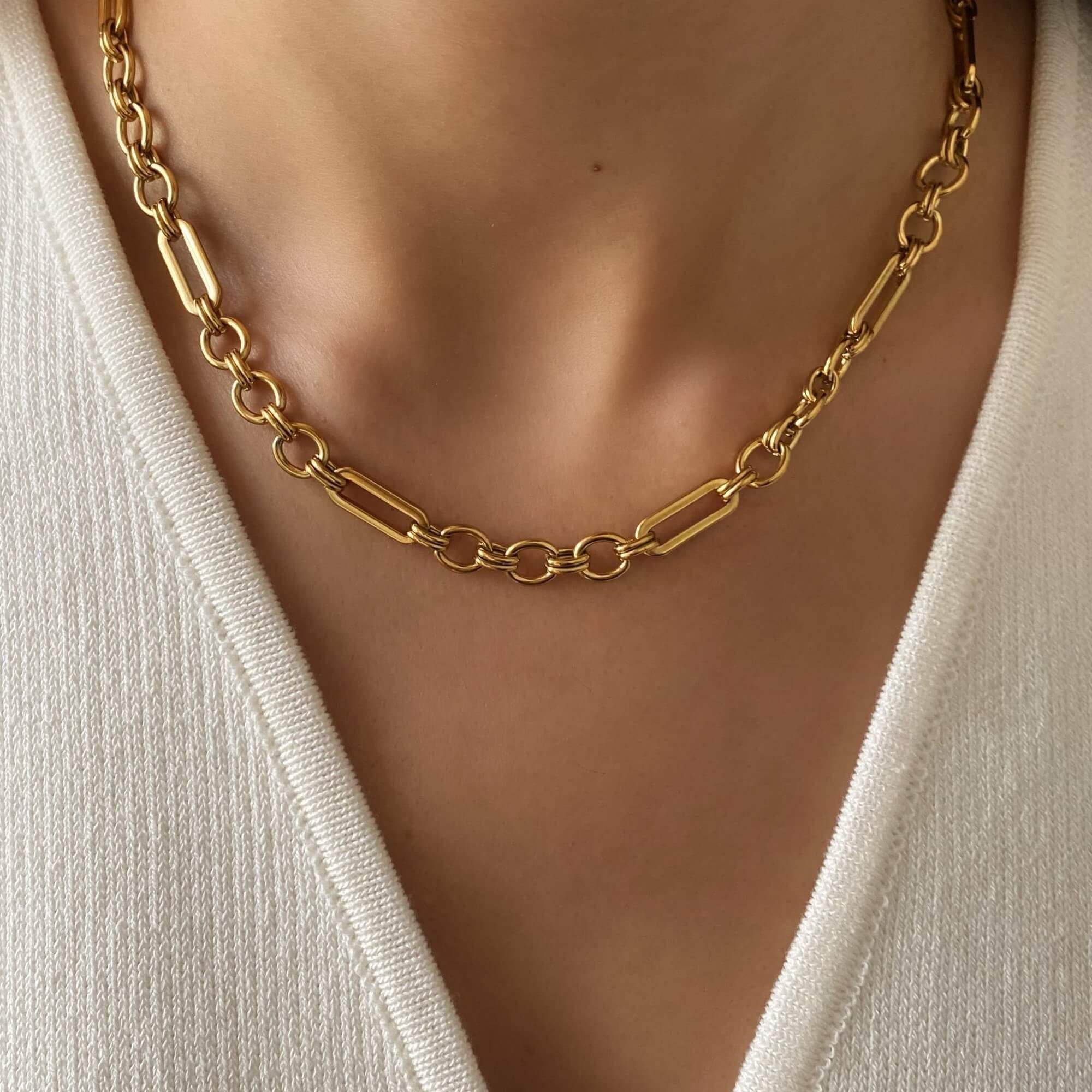The KinnN 18K gold-plated paperclip link chain choker necklace by Kampy Designs, elegantly worn to highlight its contemporary and versatile design.