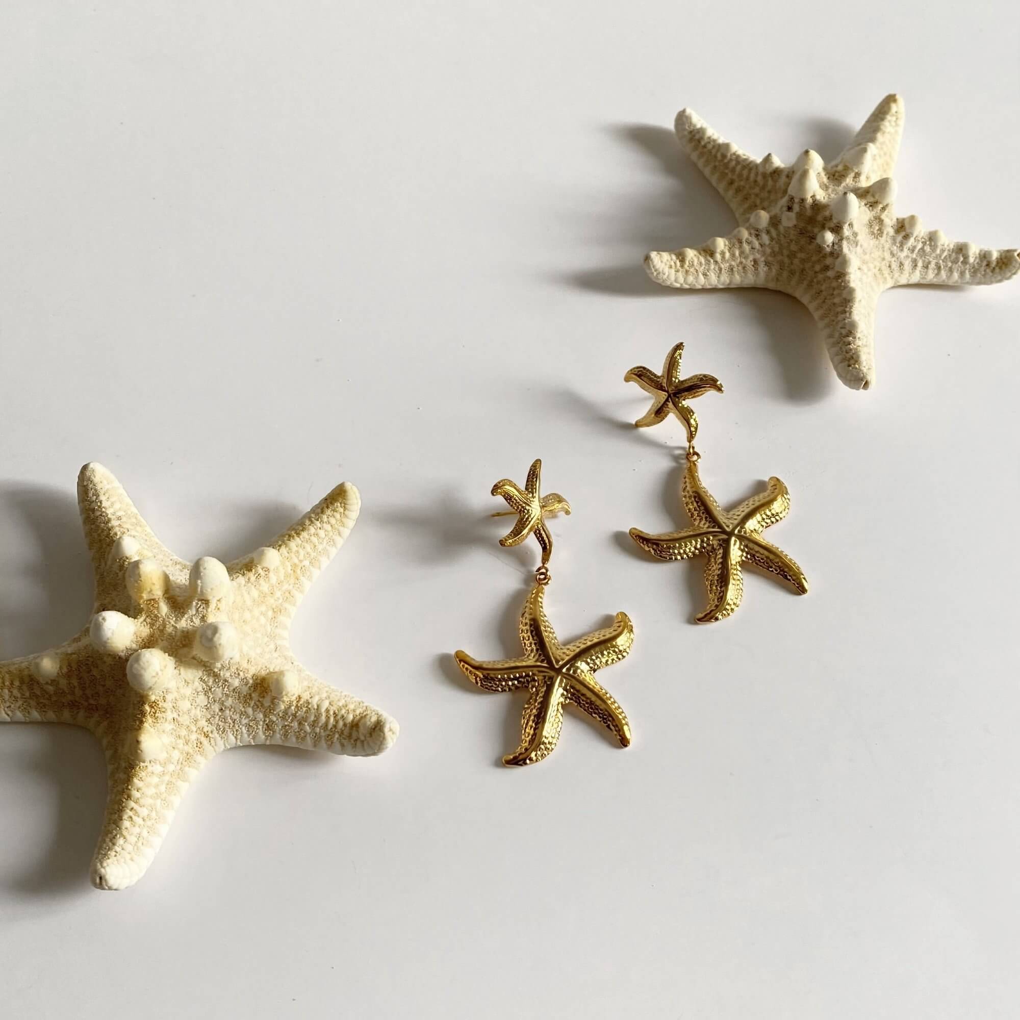 Full view of the KetaroE 18K gold-plated starfish dangle earrings by Kampy Designs, displaying their detailed starfish pattern and elegant drop style.