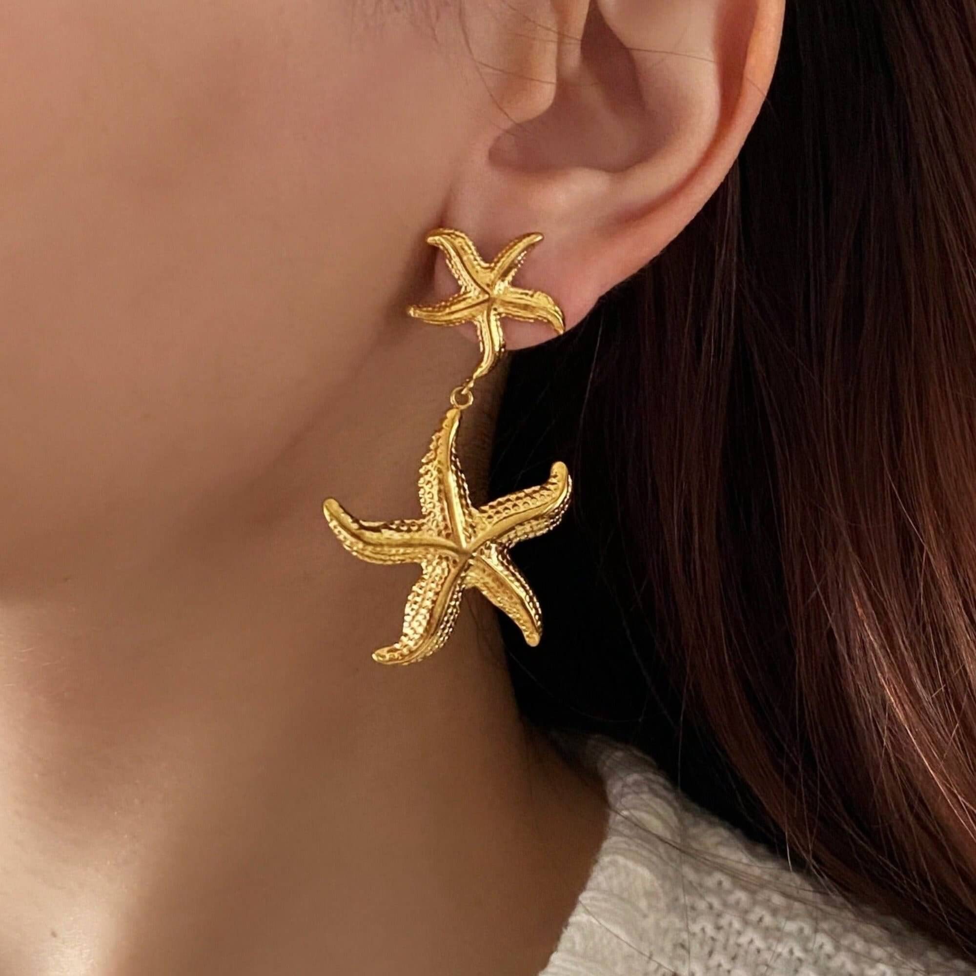 The KetaroE 18K gold-plated starfish dangle earrings by Kampy Designs, beautifully worn to highlight their ocean-inspired charm and elegant drop design.