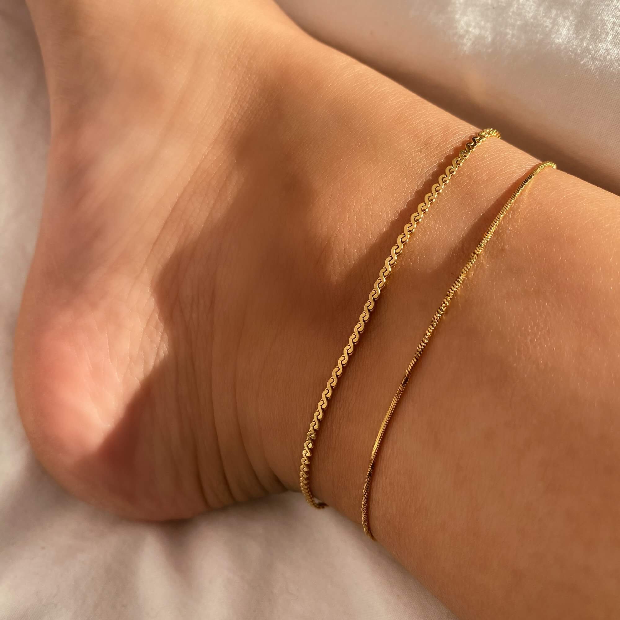 Close-up of the KasaA 18K gold-plated thin chain anklet by Kampy Designs, showcasing its fine craftsmanship and high-shine gold finish.