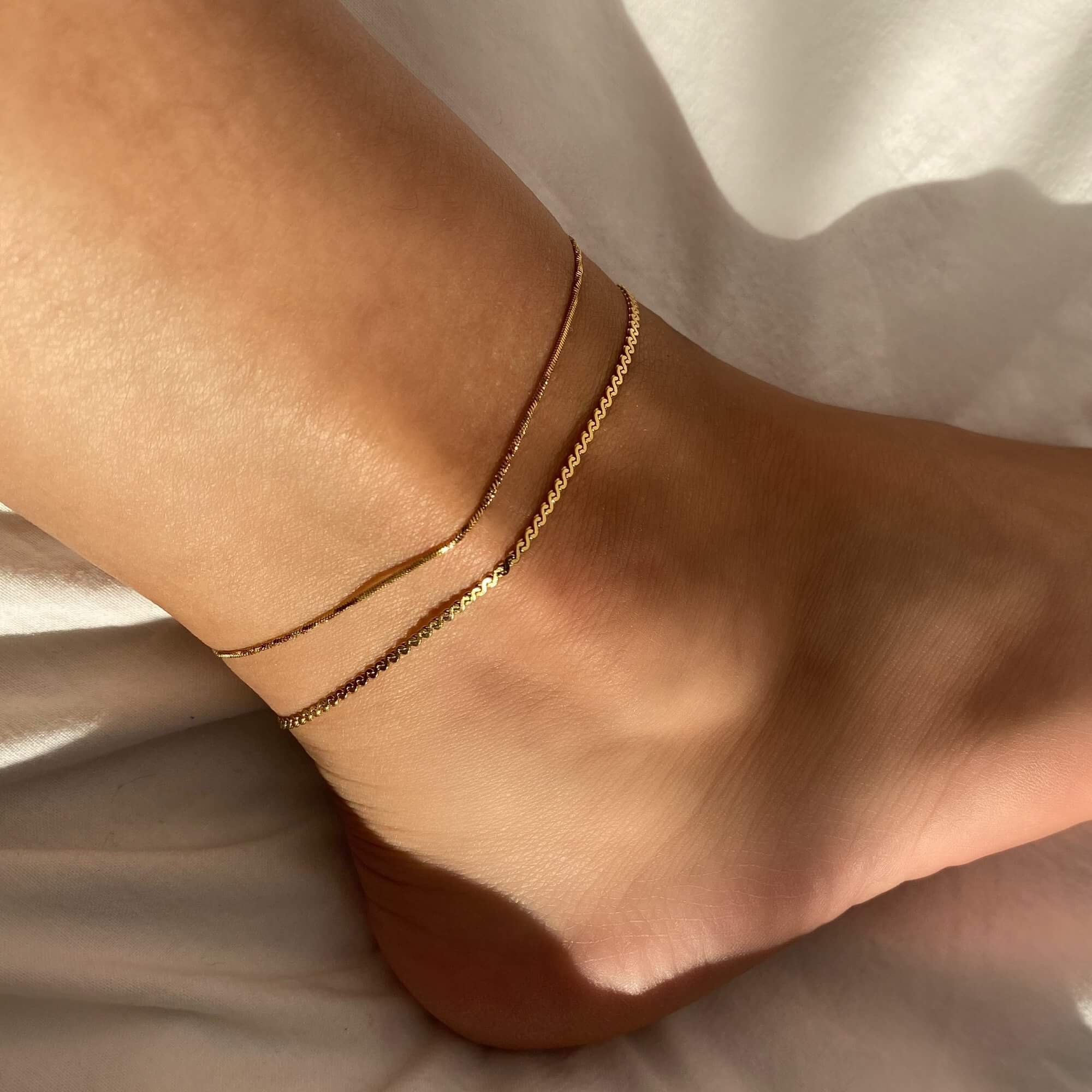 Side view of the KasaA 18K gold-plated thin chain anklet by Kampy Designs, emphasizing its smooth, sleek design and comfortable fit.