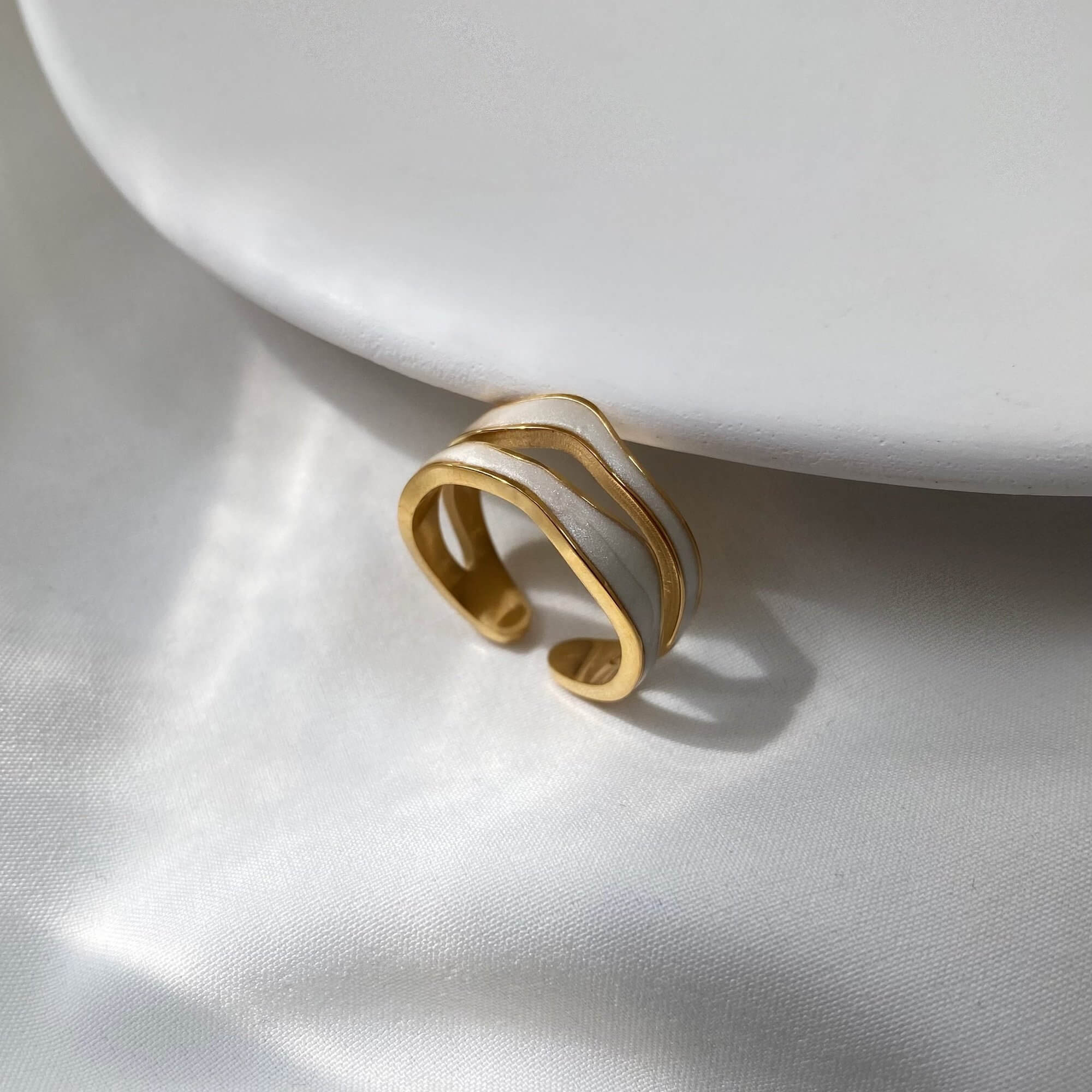 Front view of the KalaR 18K gold-plated white enamel wave ring by Kampy Designs, showcasing its unique, wavy band and modern aesthetic.