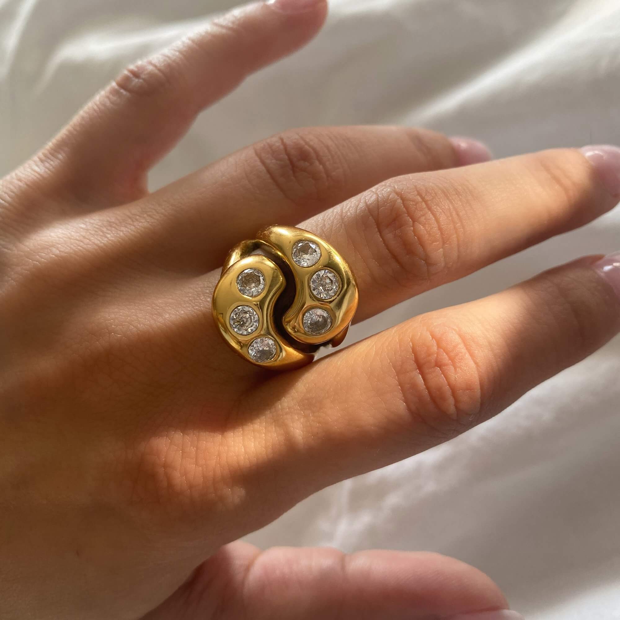 Close-up of the KassyR 18K gold-plated yin-yang CZ ring by Kampy Designs, showcasing its intricate yin-yang design with sparkling cubic zirconia stones.