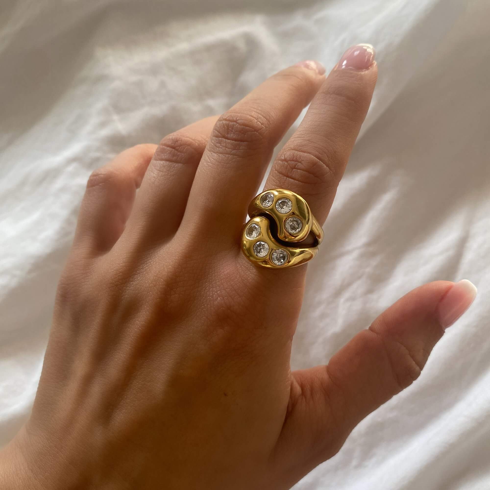 The KassyR 18K gold-plated yin-yang CZ ring by Kampy Designs, worn at an alternative angle to highlight its unique spiritual symbolism.