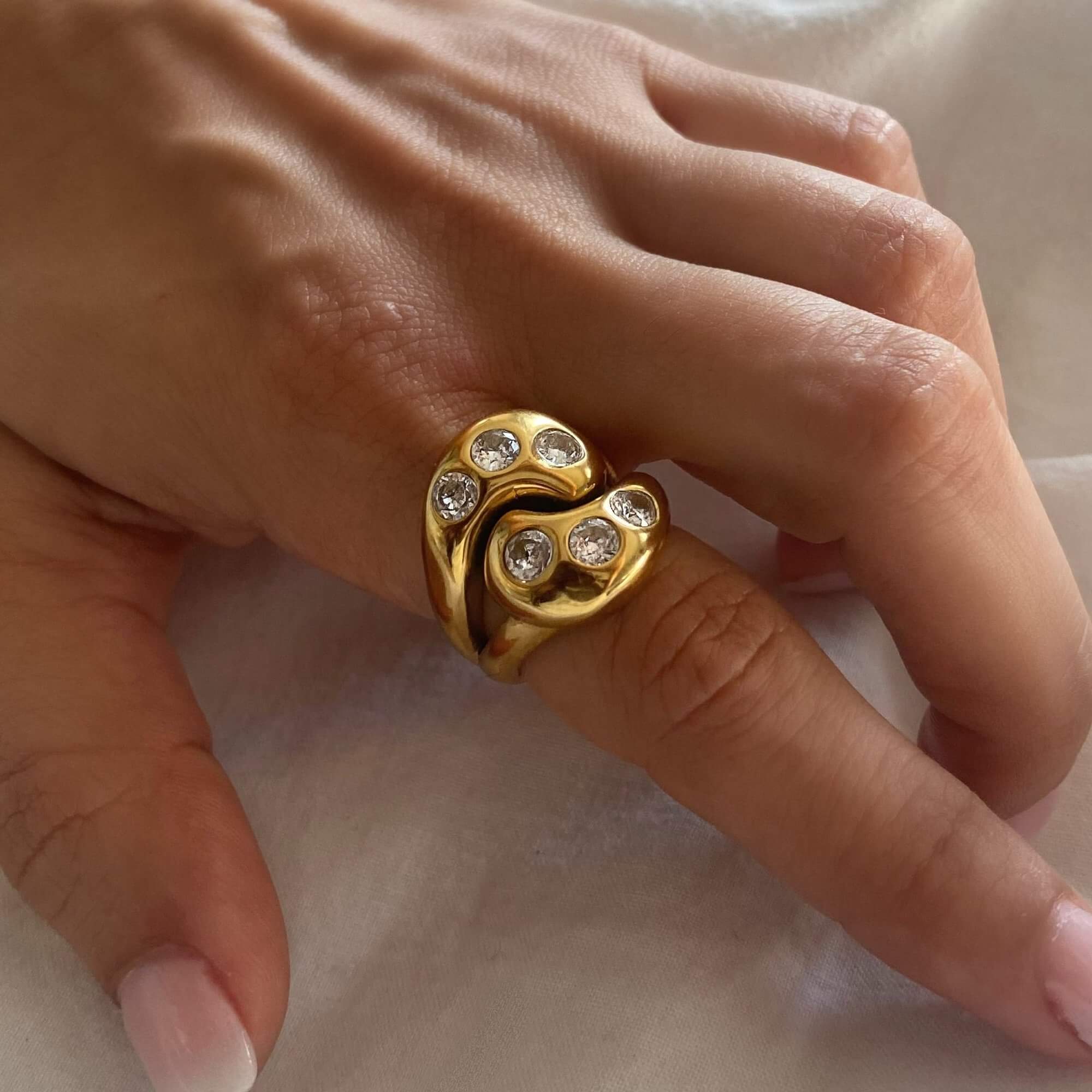 The KassyR 18K gold-plated yin-yang CZ ring by Kampy Designs, elegantly worn to emphasize its balance of light and dark energies.