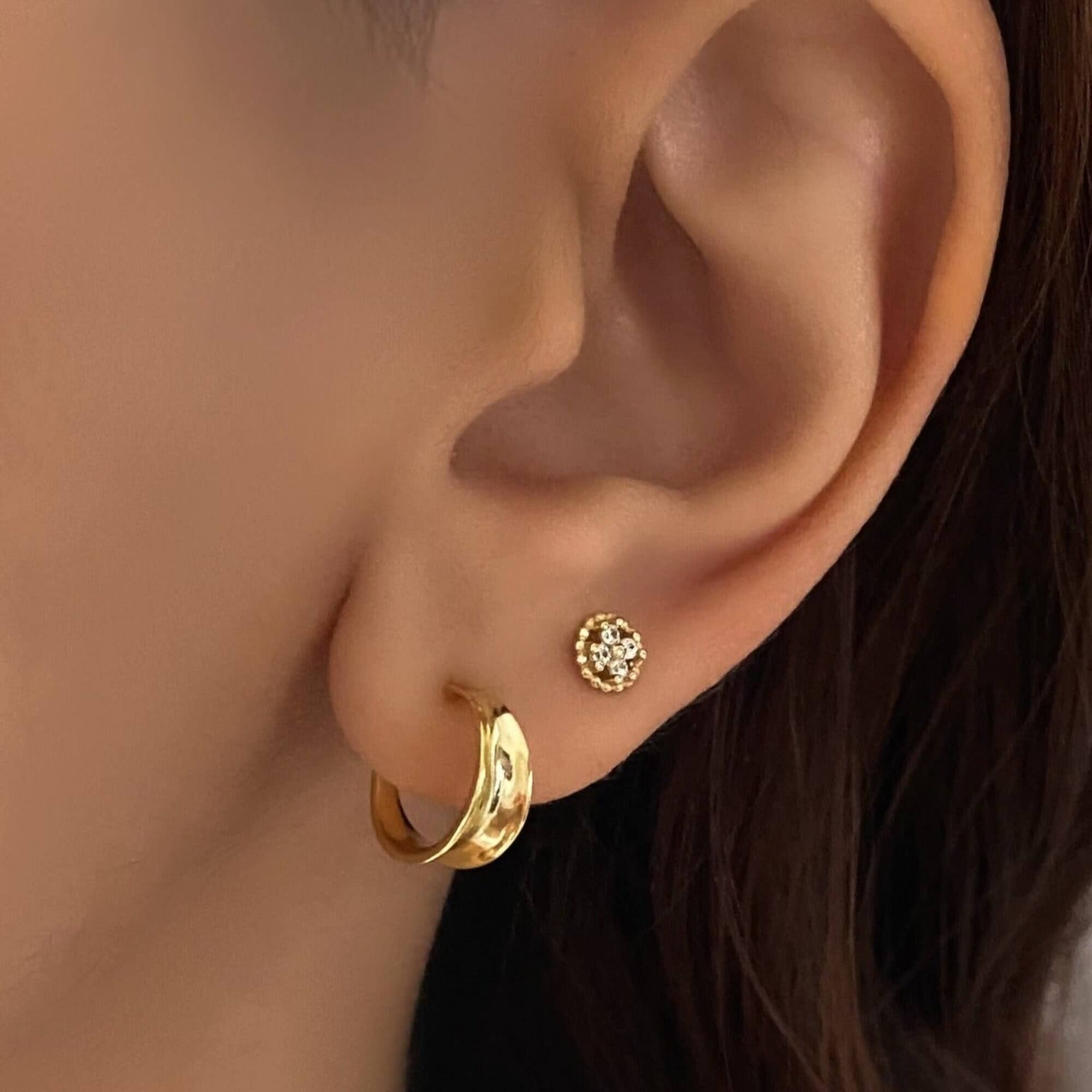 The KonyE 925 sterling silver tiny clover stud earrings by Kampy Designs, beautifully worn to showcase their delicate and stylish look.